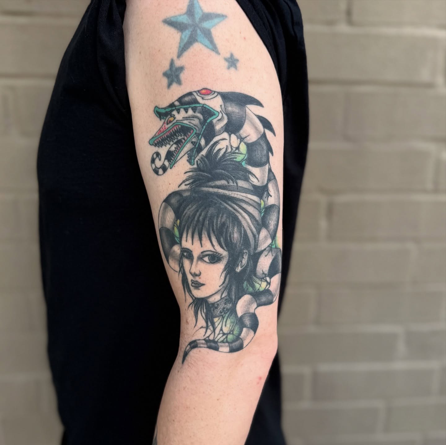 Woman with snake realism tattoo on the forearm by Scott Kulikowski