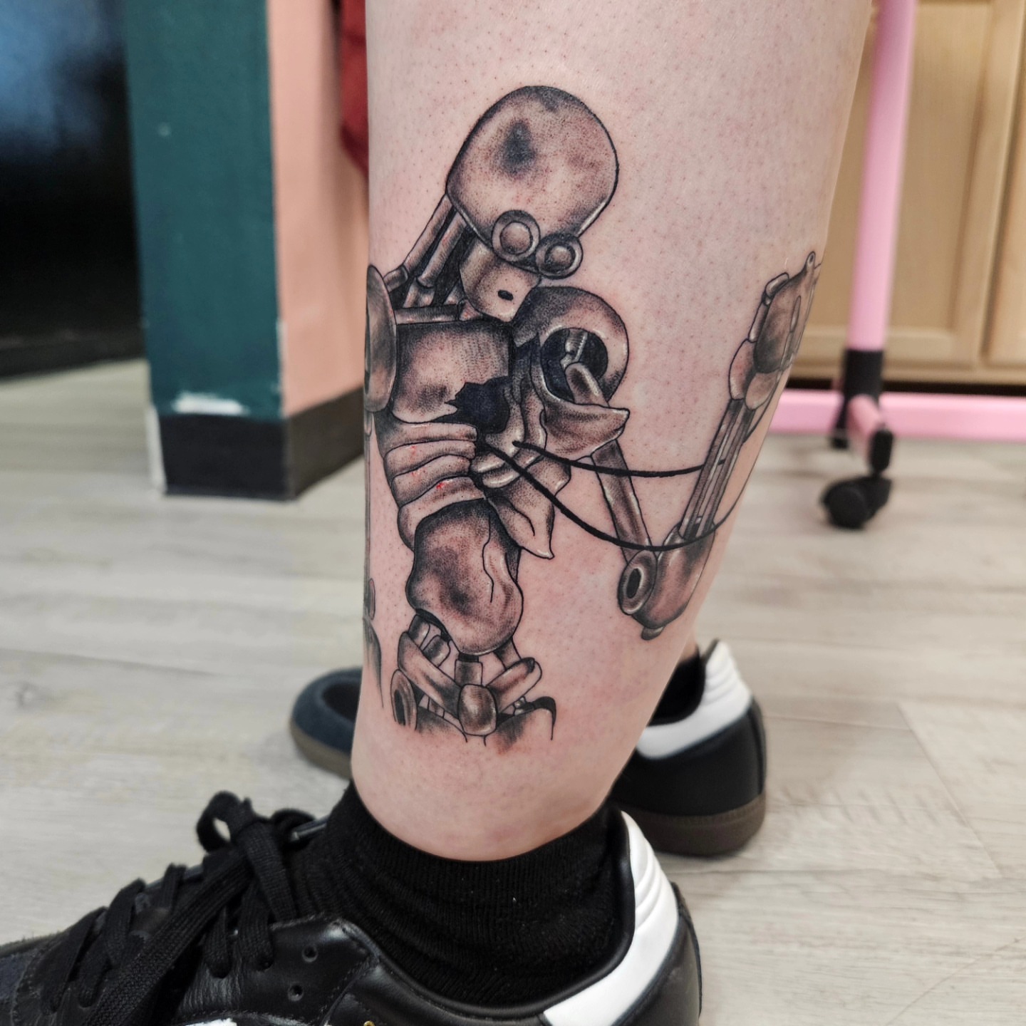 Robot black and grey tattoo on the calf by Ari🖤