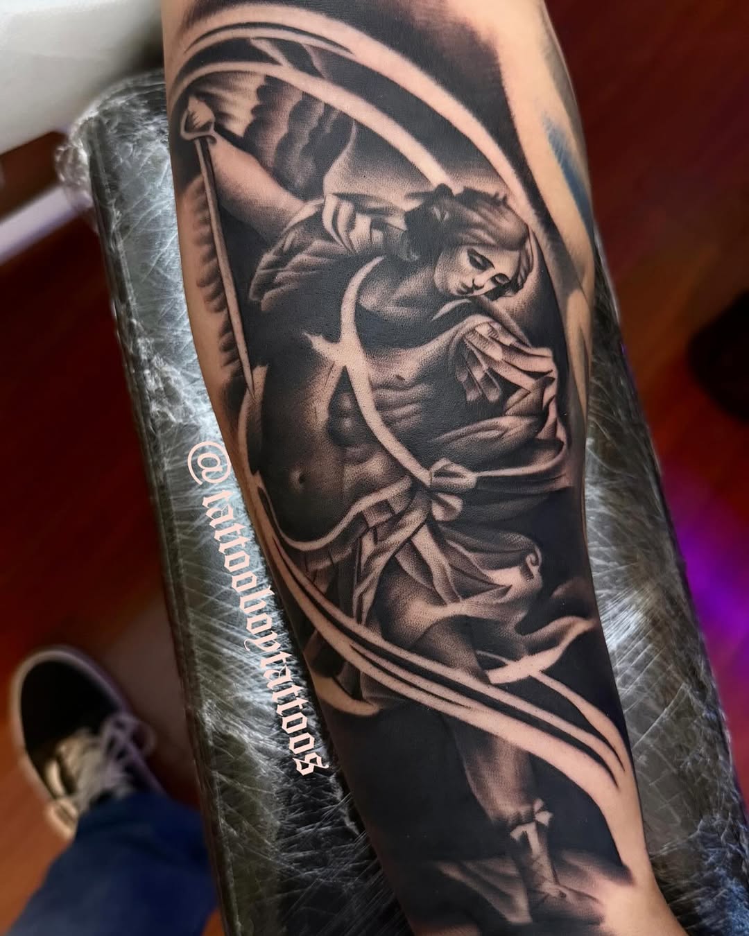 Angelic figure with sword realism tattoo on the forearm by TattooBoyTattoos