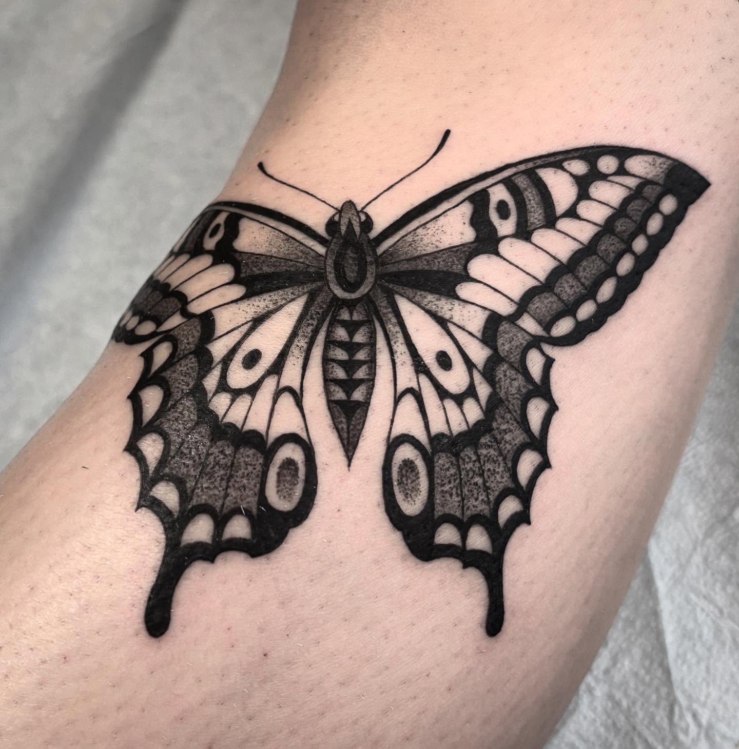 Butterfly dotwork tattoo on the thigh by Pat Moser