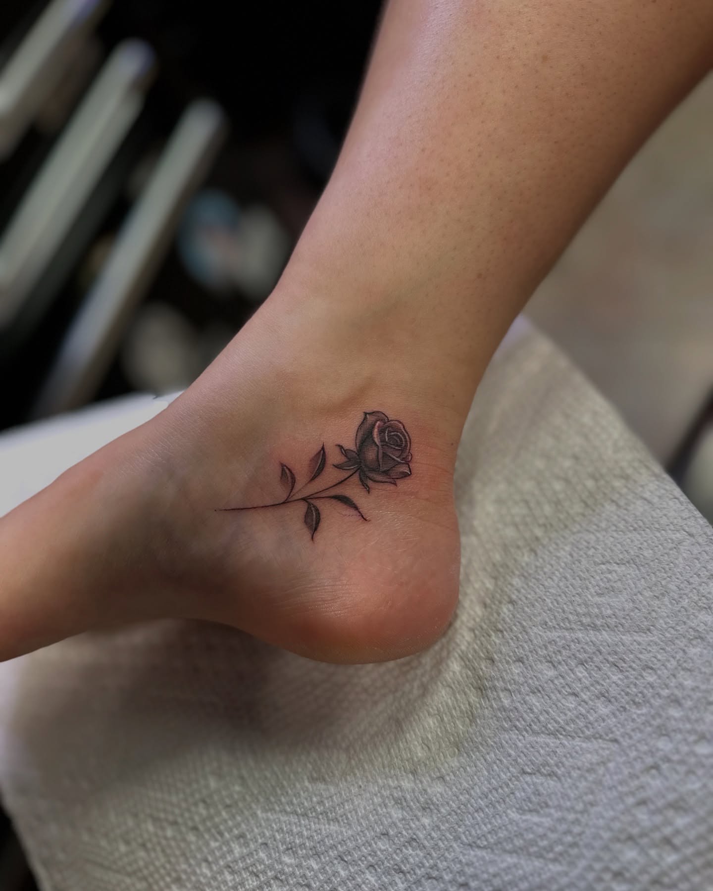Rose black and grey tattoo on the foot by chris tattoo