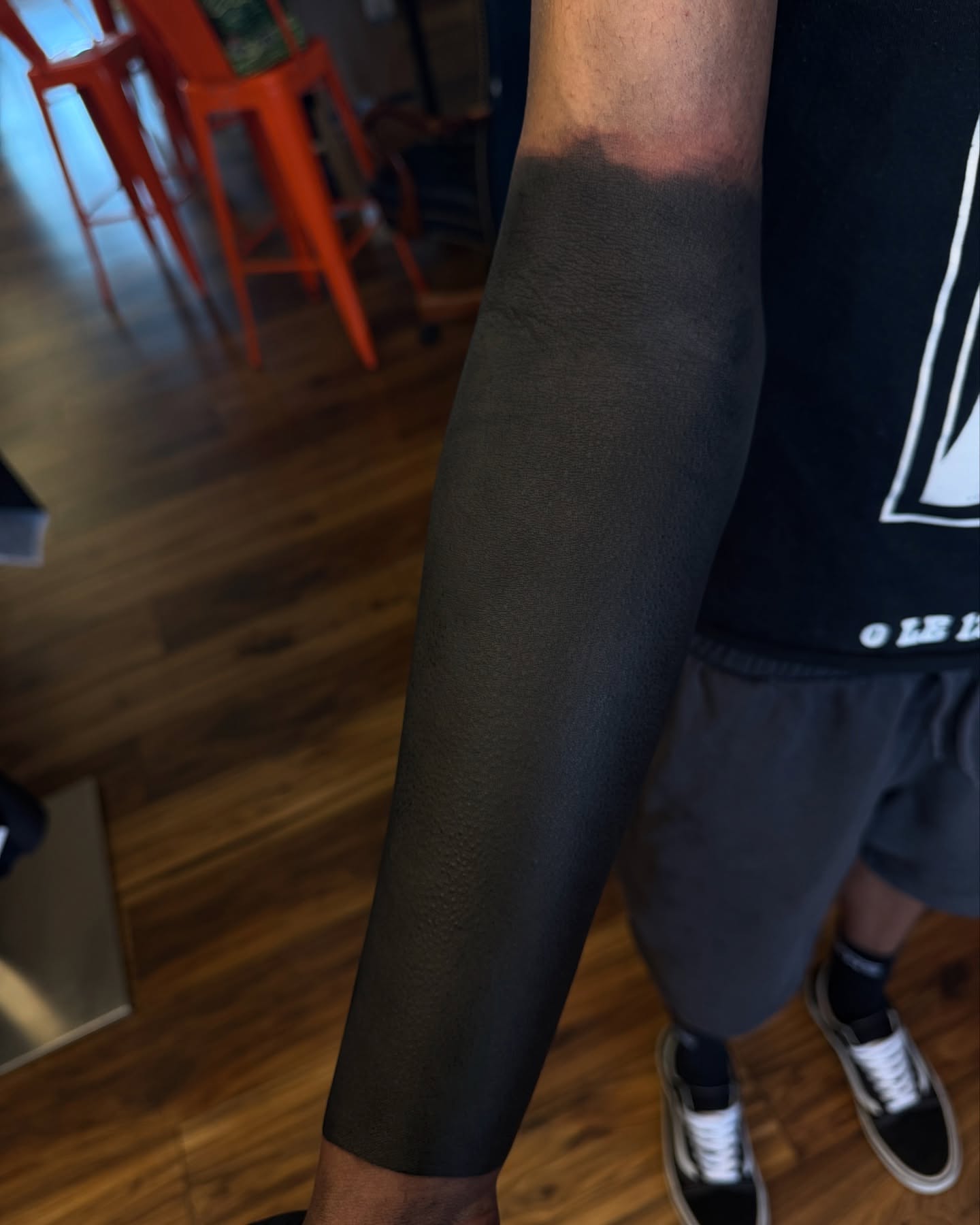 Solid black sleeve black and grey tattoo on the upper arm by Denver Blackout Tattoo Specialist - Anthony