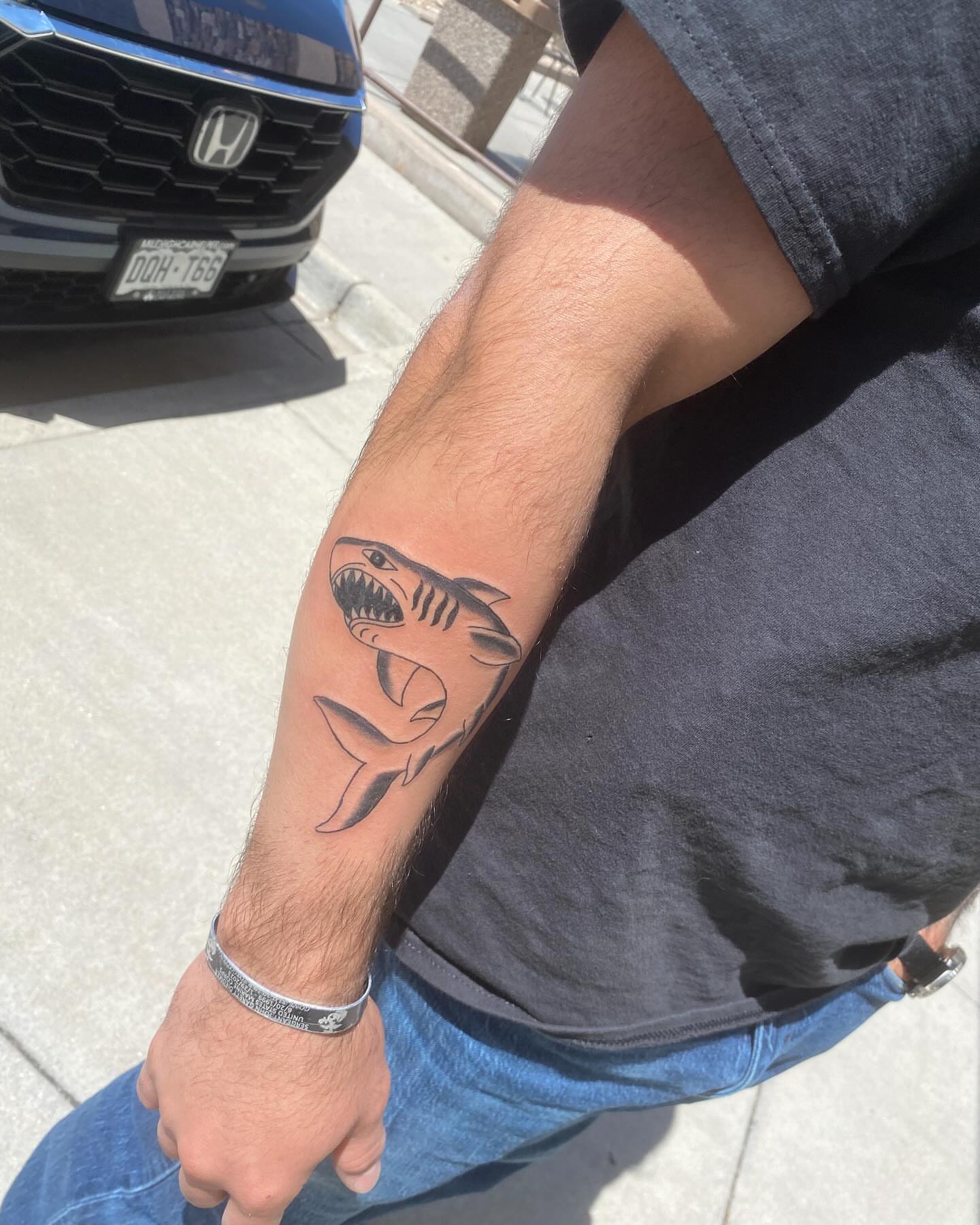Shark black and grey tattoo on the forearm by Adrián Banuelos