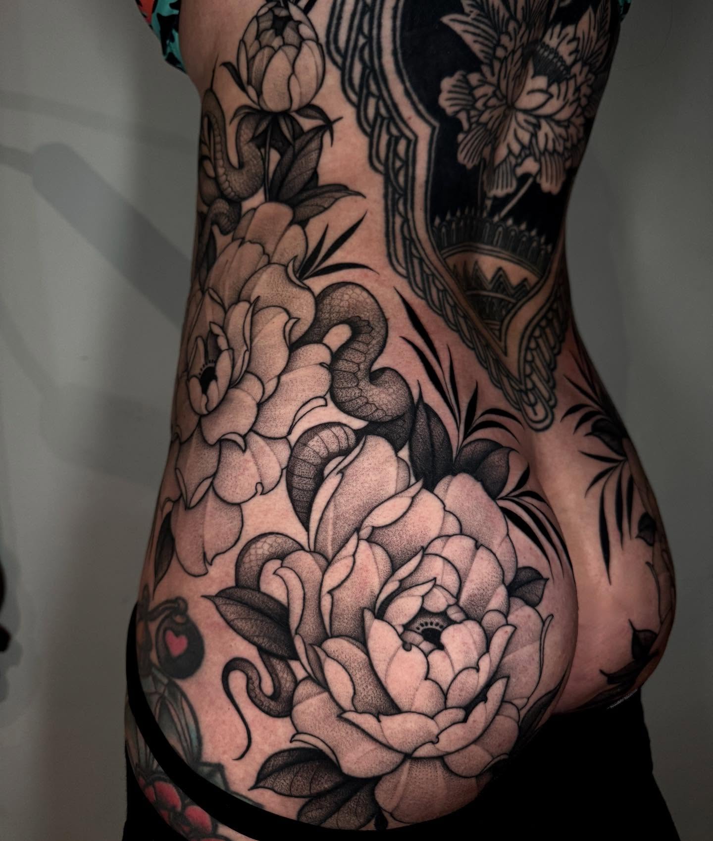 Peony flowers American traditional tattoo on the torso by Lauren Llerandi
