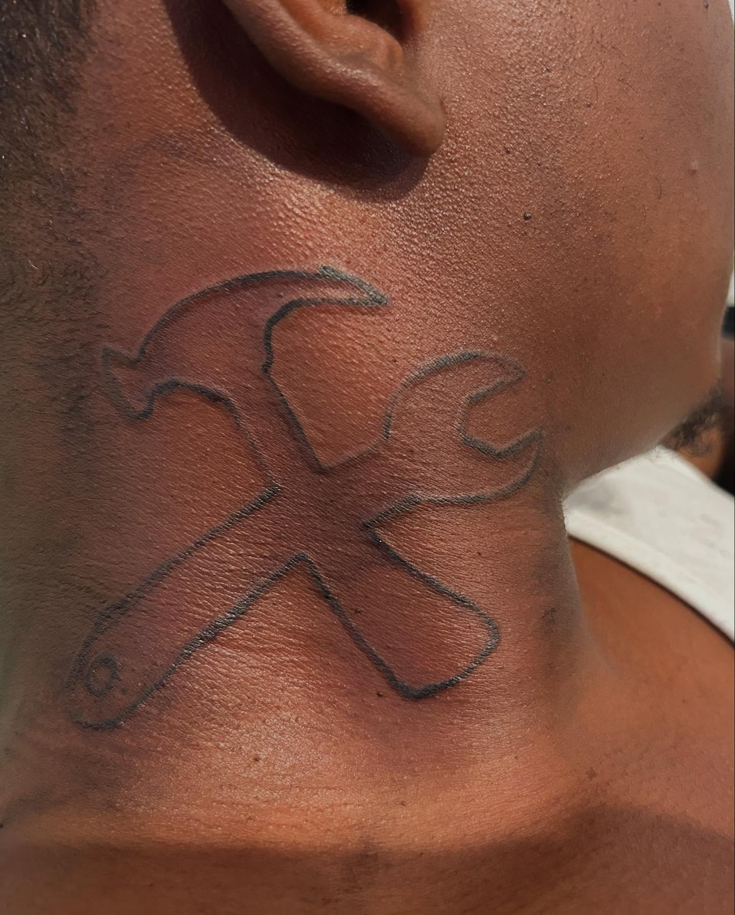 Abstract figure geometric tattoo on the neck by Airika Edwards