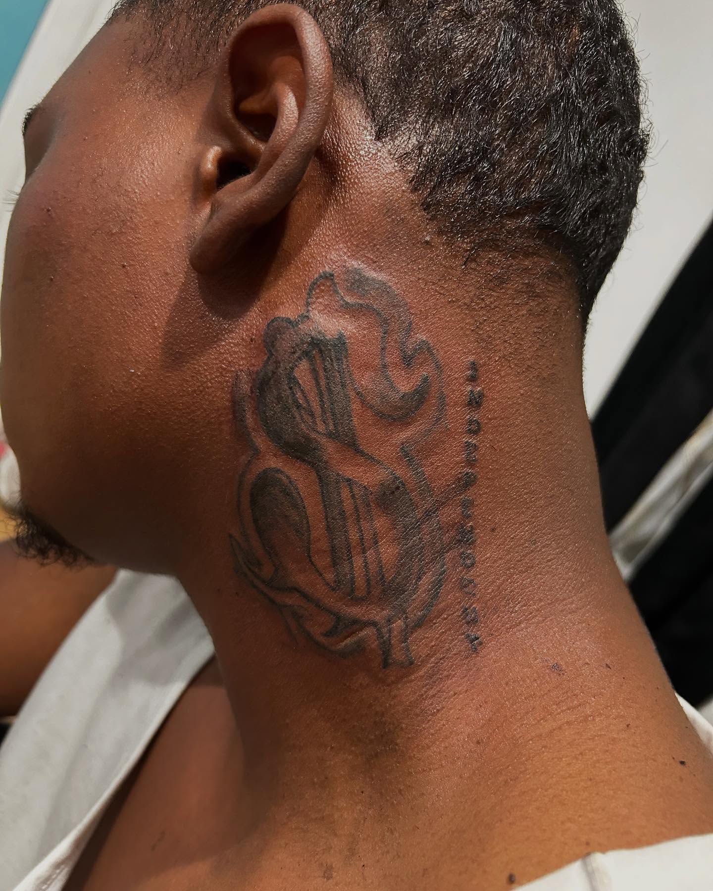 Musical instrument black and grey tattoo on the neck by Airika Edwards