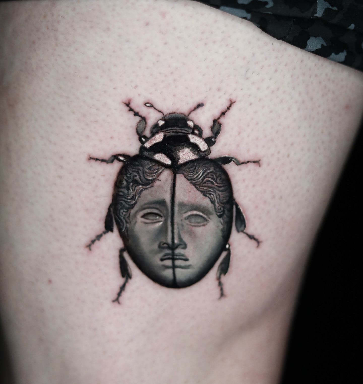 Beetle with face realism tattoo on the thigh by memo