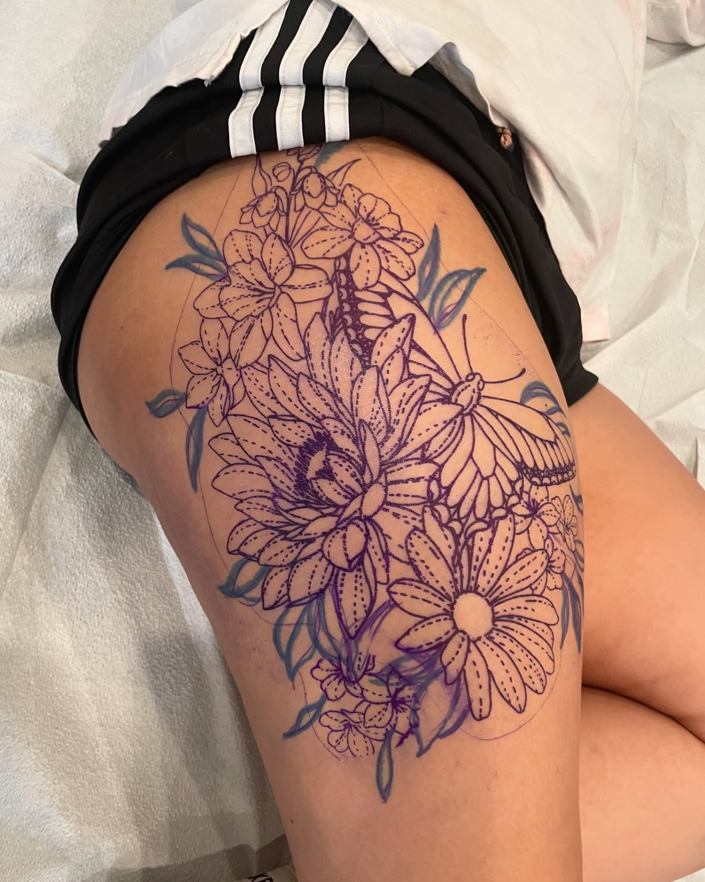 Flowers and butterfly dotwork tattoo on the thigh by 𝕯𝖔𝖒