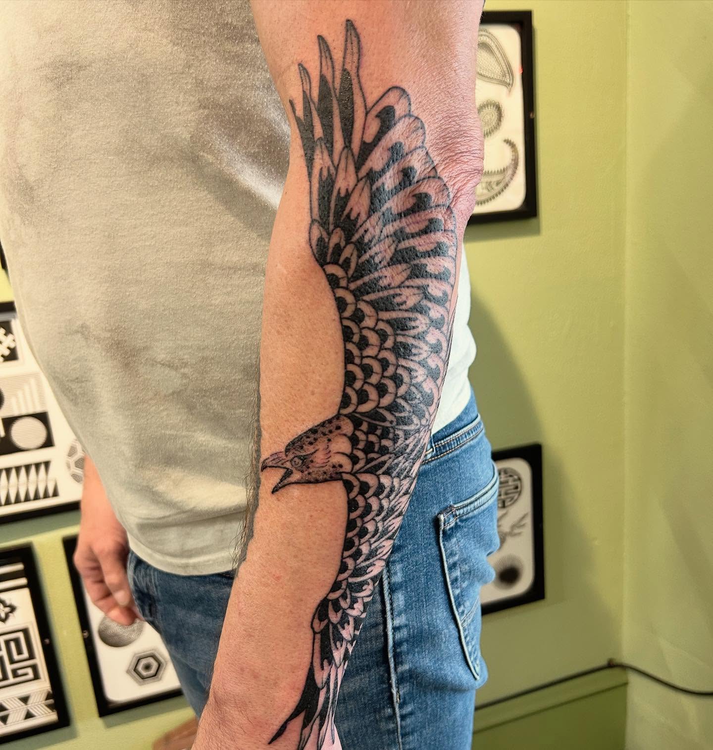 Bird black and grey tattoo on the forearm by Erica Finley