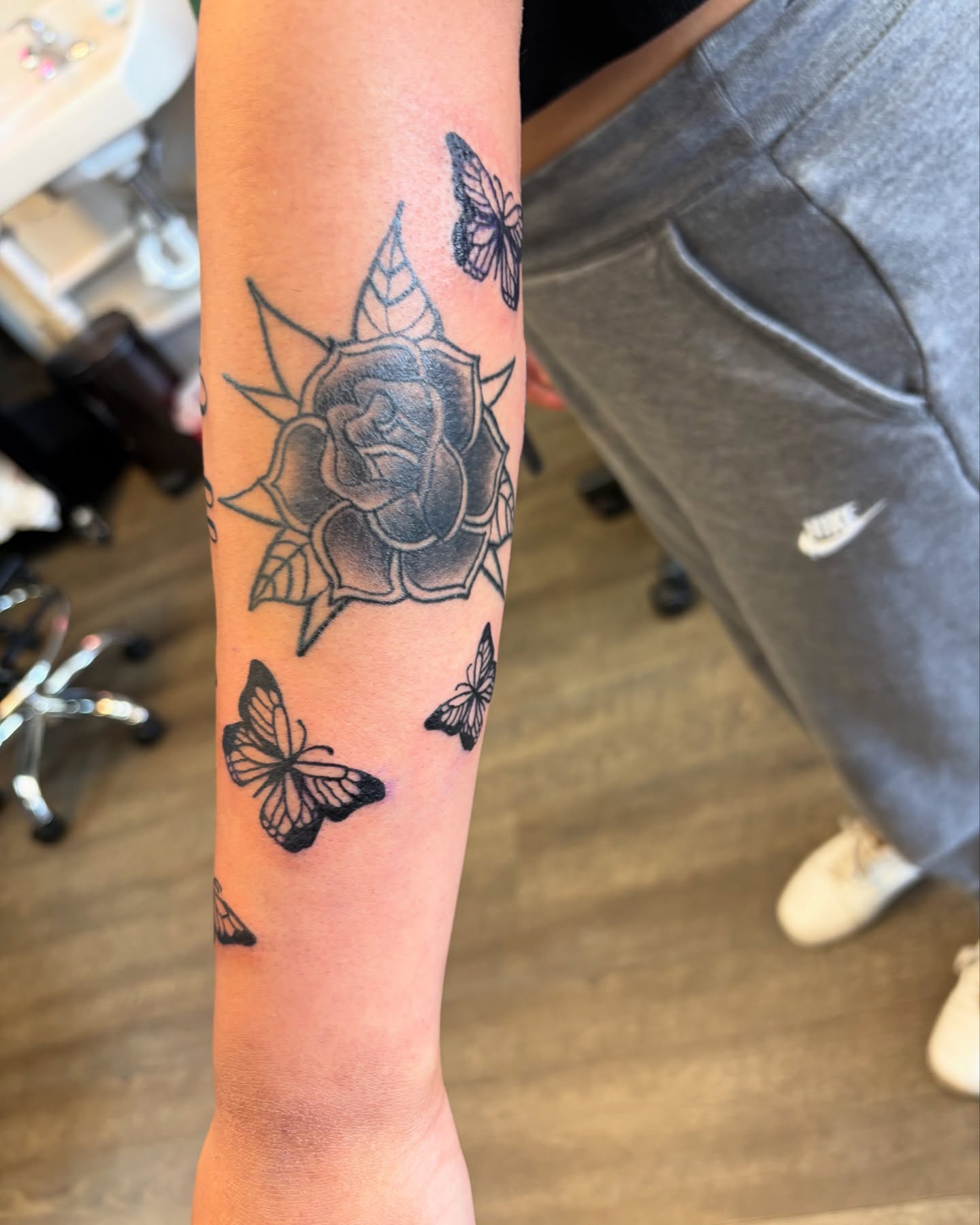 Rose and butterflies black and grey tattoo on the forearm by Tori Anderson, Minneapolis, Minnesota