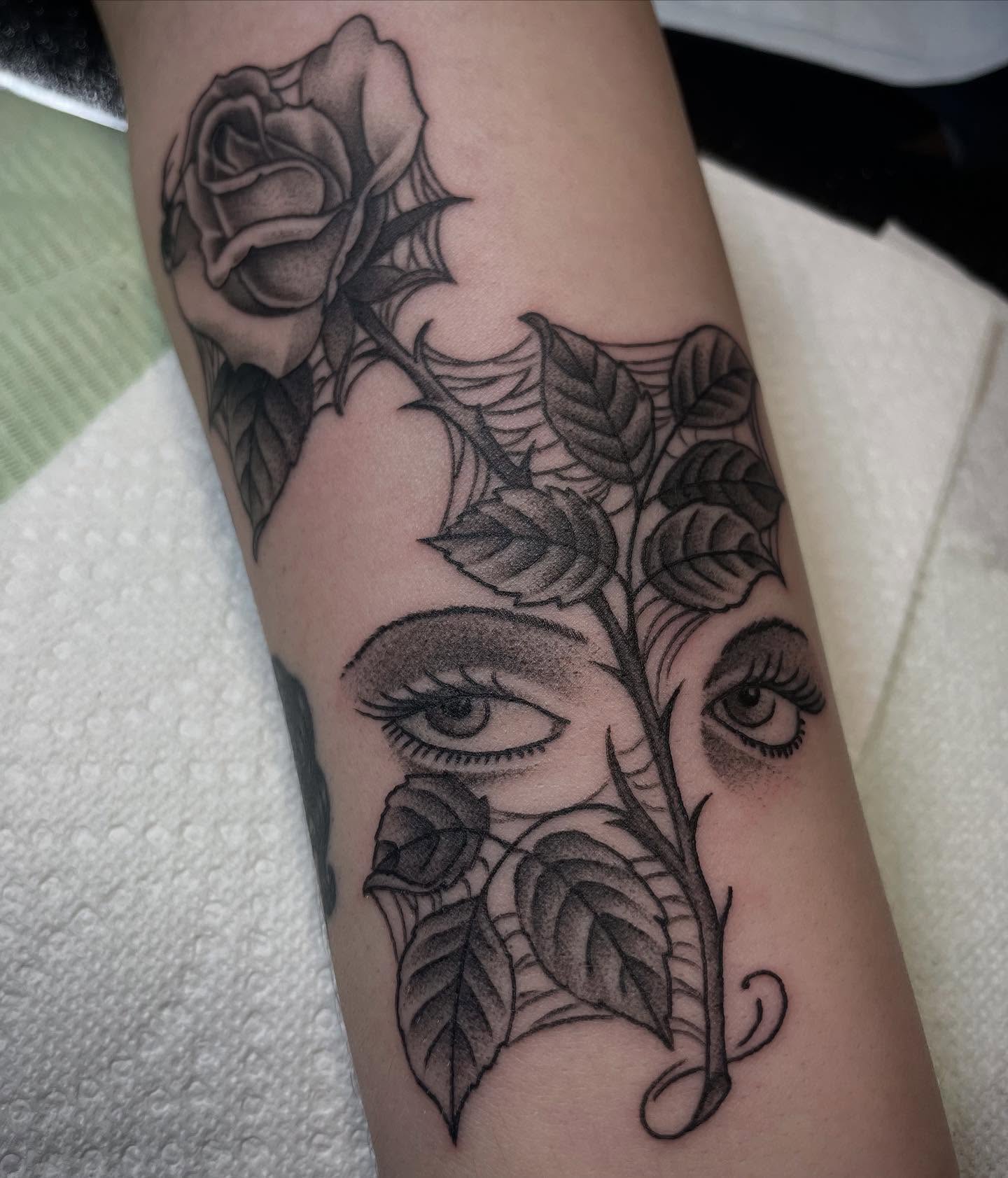 Rose and eyes realism tattoo on the forearm by Micheal McGlinchey