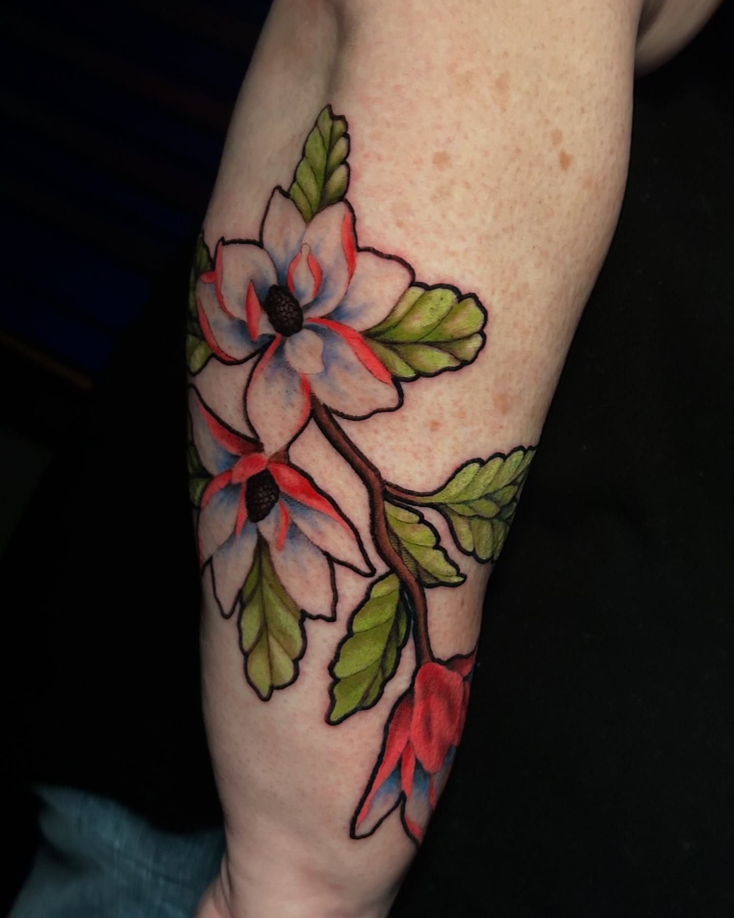 Flower watercolor tattoo on the forearm by Adrian Michigan Tattoo Artist