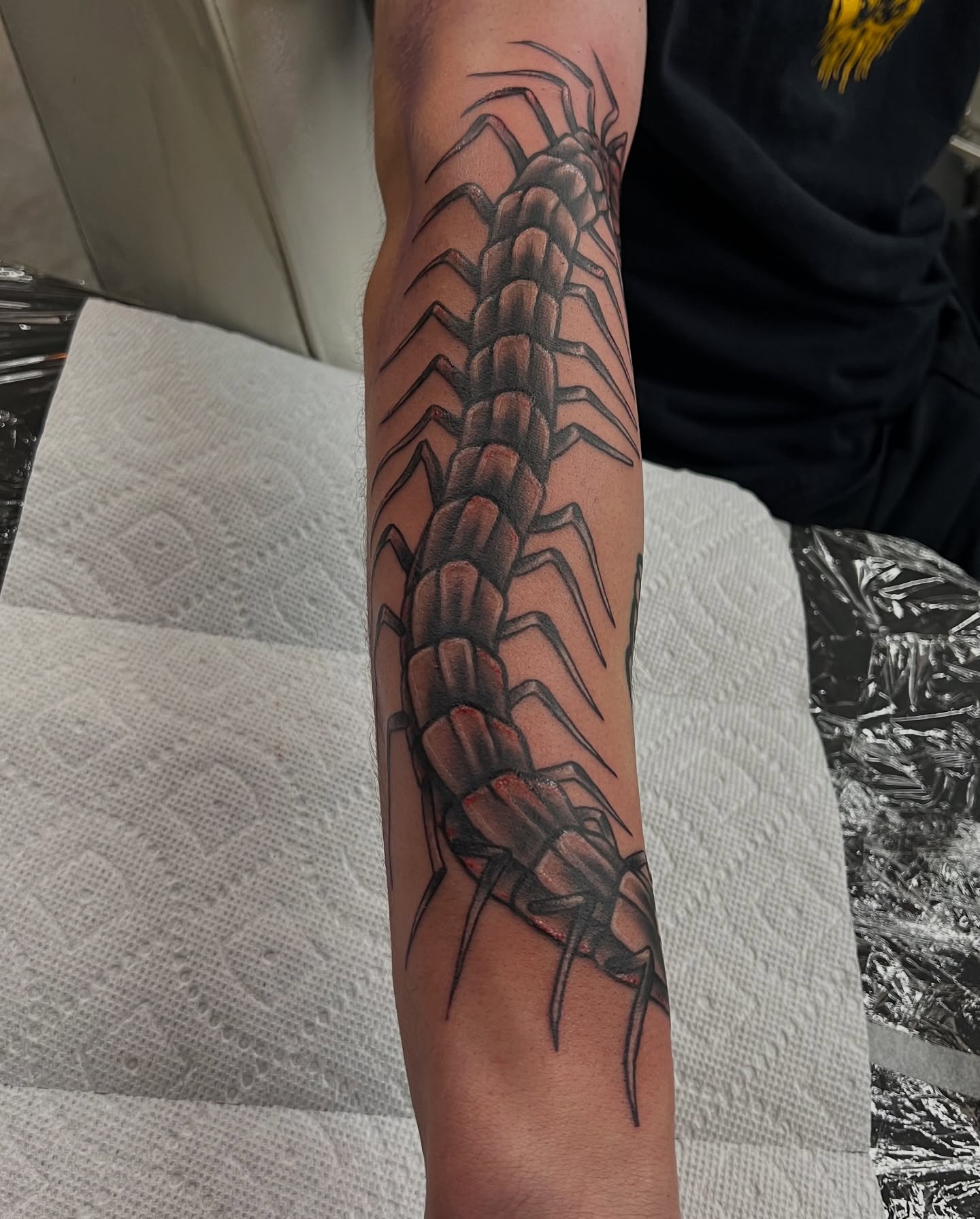 Centipede black and grey tattoo on the forearm by BodyArtByAlia