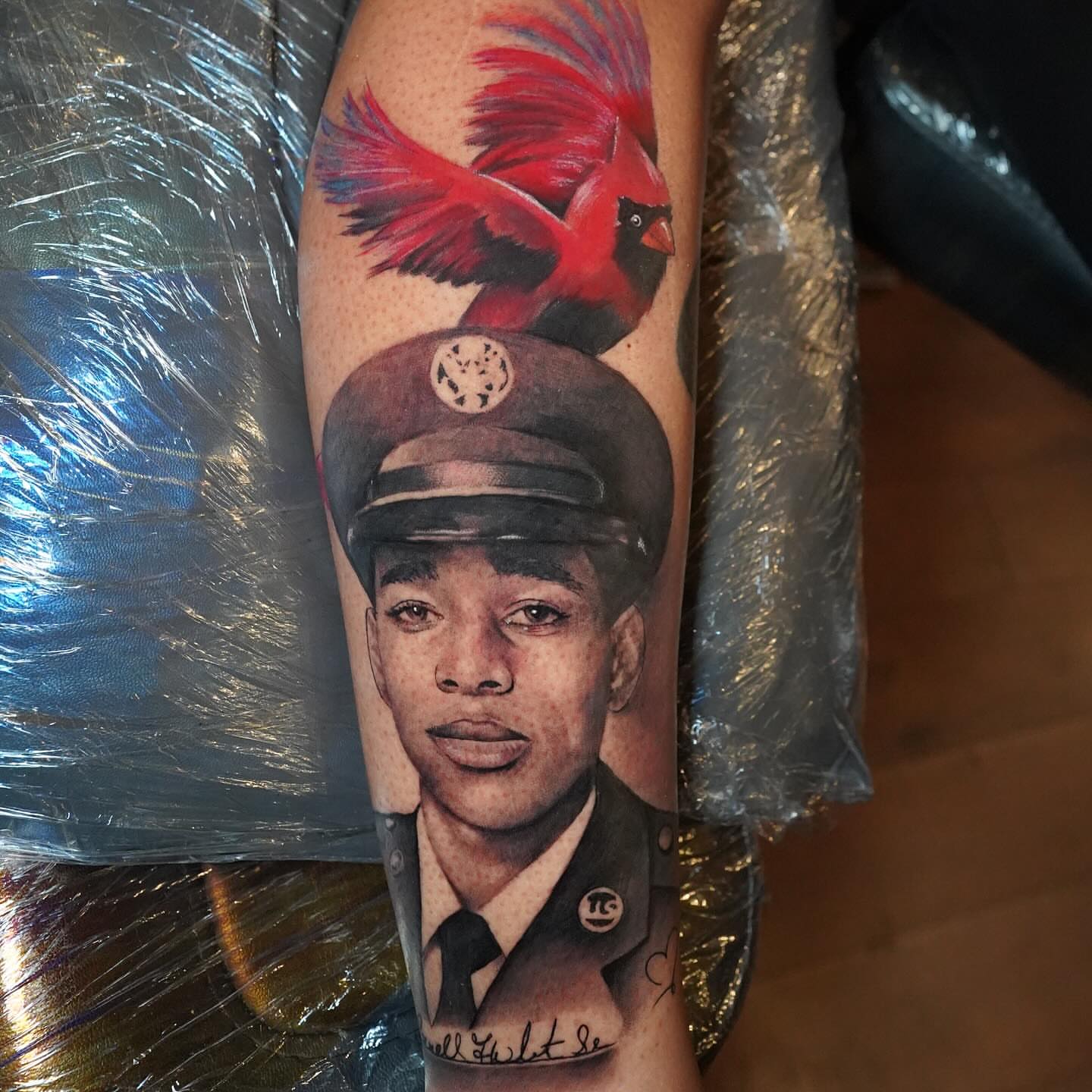 Military officer with cardinal realism tattoo on the forearm by Erick Satchell II
