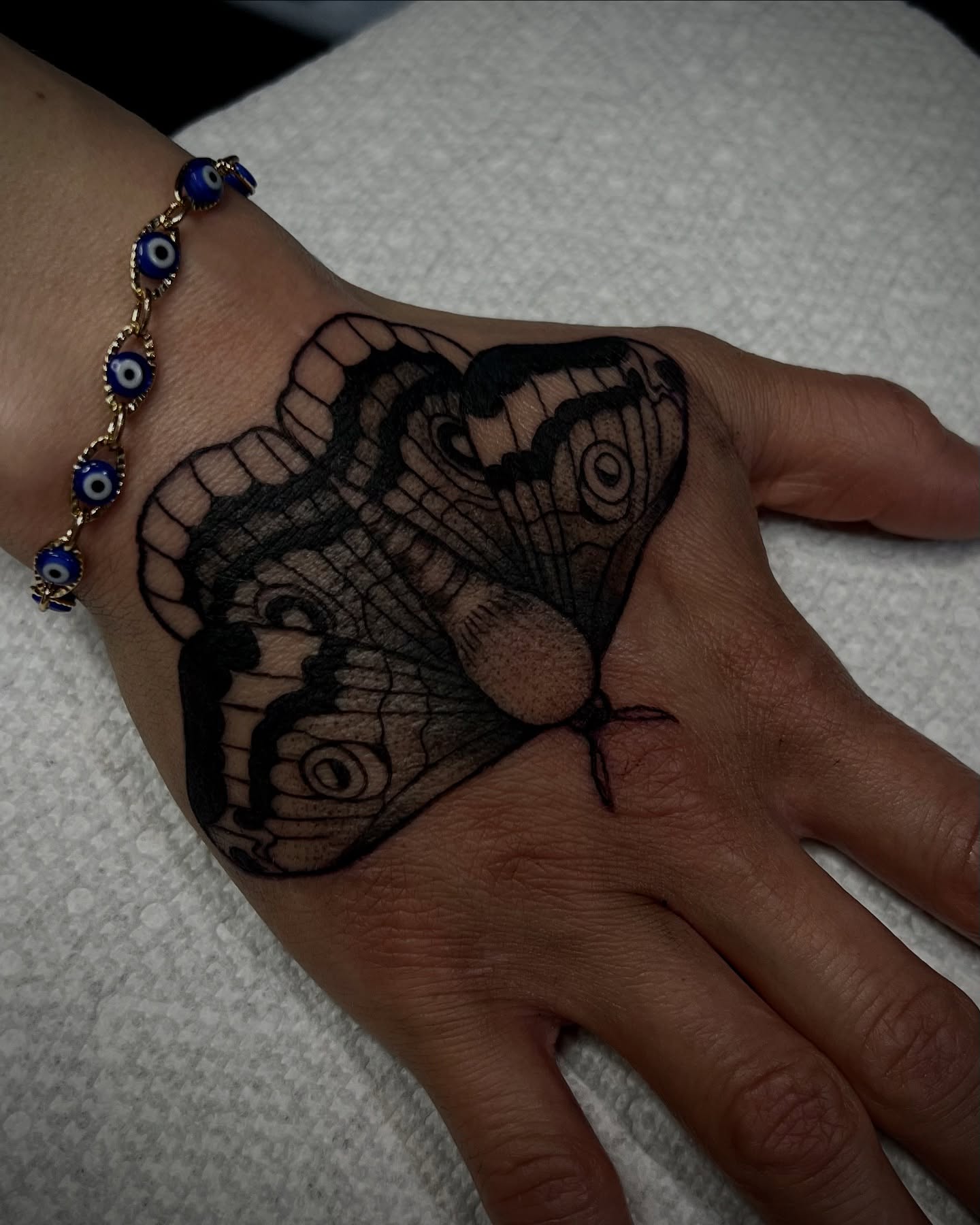 Butterfly black and grey tattoo on the hand by Stevie Reign