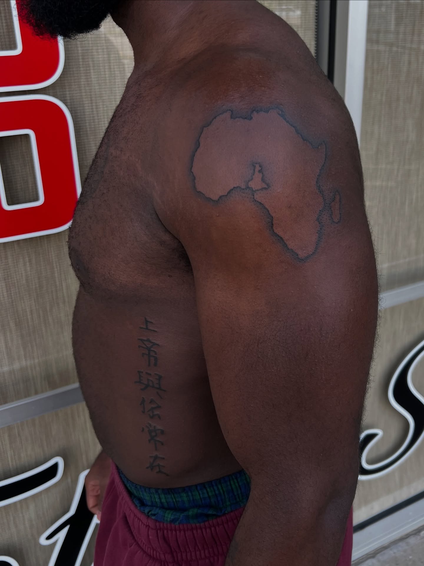 Map of Africa black and grey tattoo on the shoulder by tatman cris 🥀 dfw tattoo artist