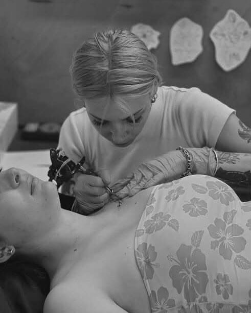 Floral design black and grey tattoo on the chest by Amara Lyons, Matakana, New Zealand