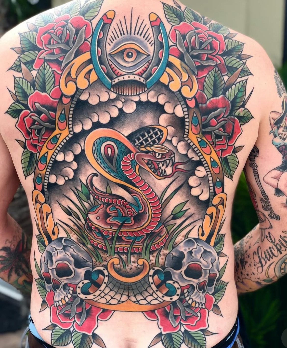 Snake and skull American traditional tattoo on the back by Dave Kruseman