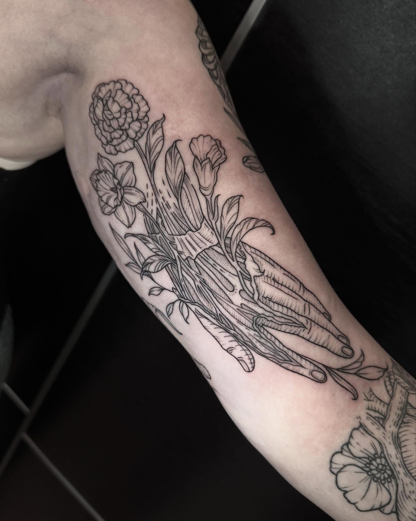 Floral arrangement black and grey tattoo on the forearm by Kirsten Marsden Ballantyne