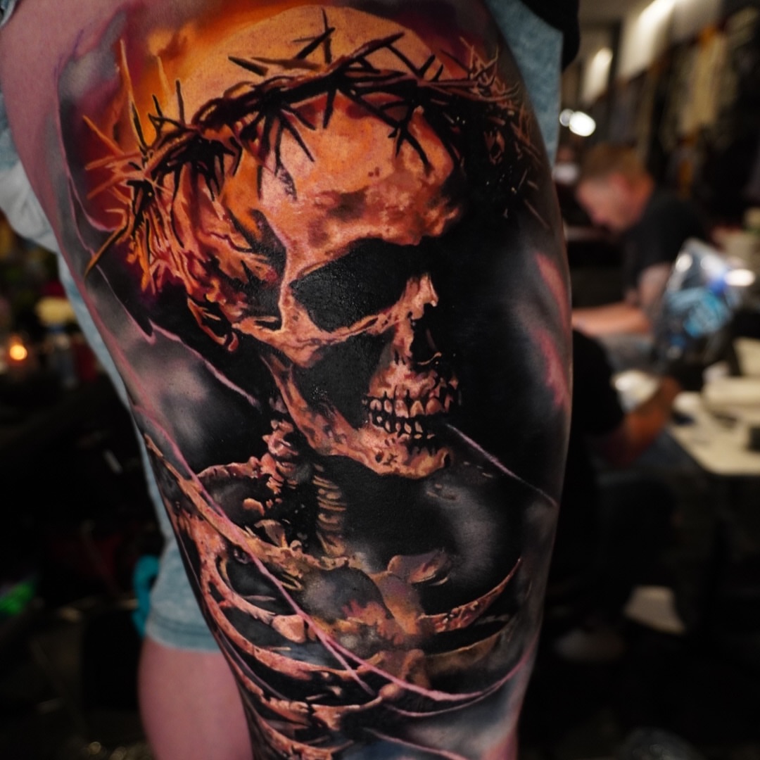 Skull with crown of thorns dark realism tattoo on the forearm by Justin Shelpman