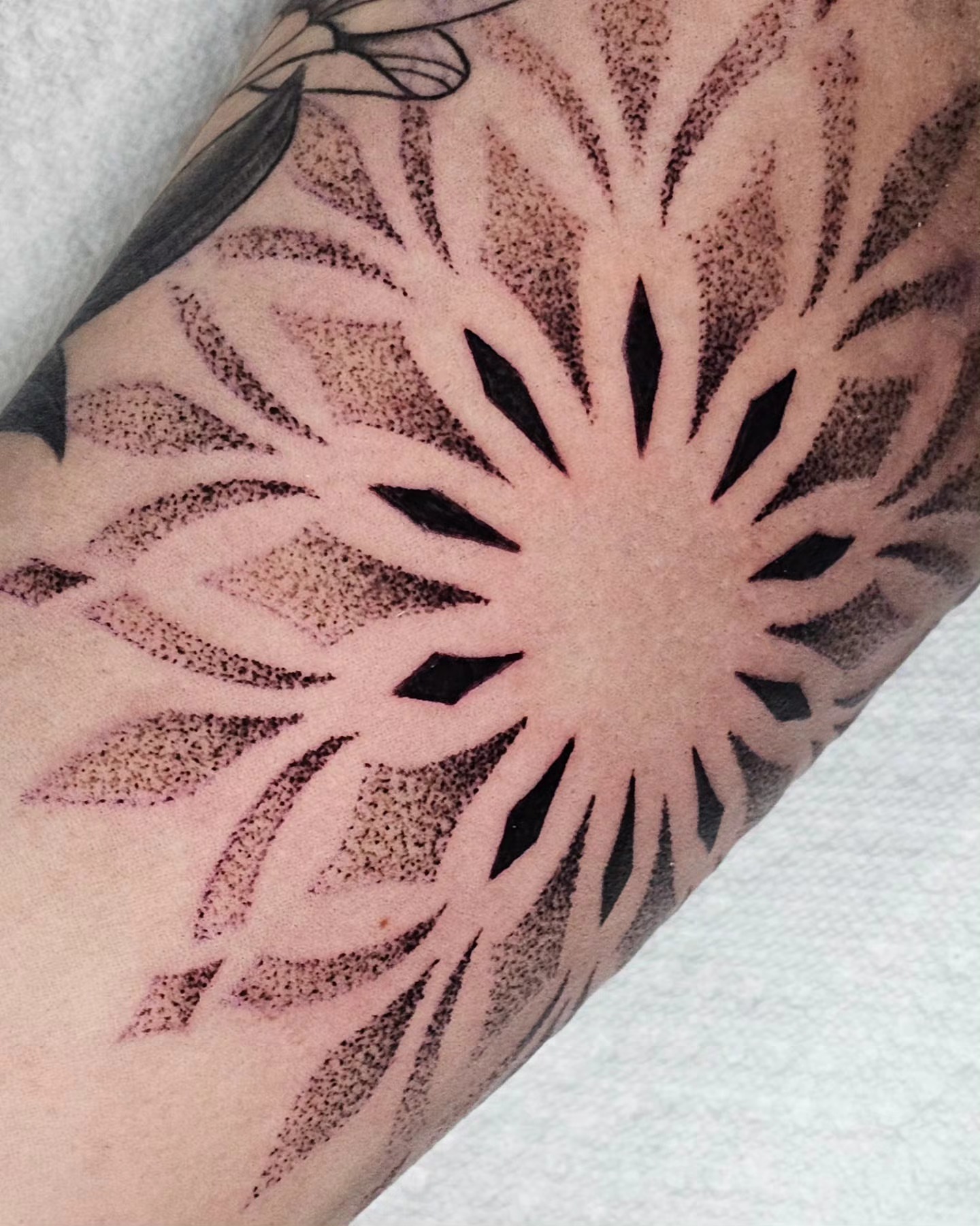 Sunburst dotwork tattoo on the forearm by Kelsey Lorrae, Ankeny, Iowa