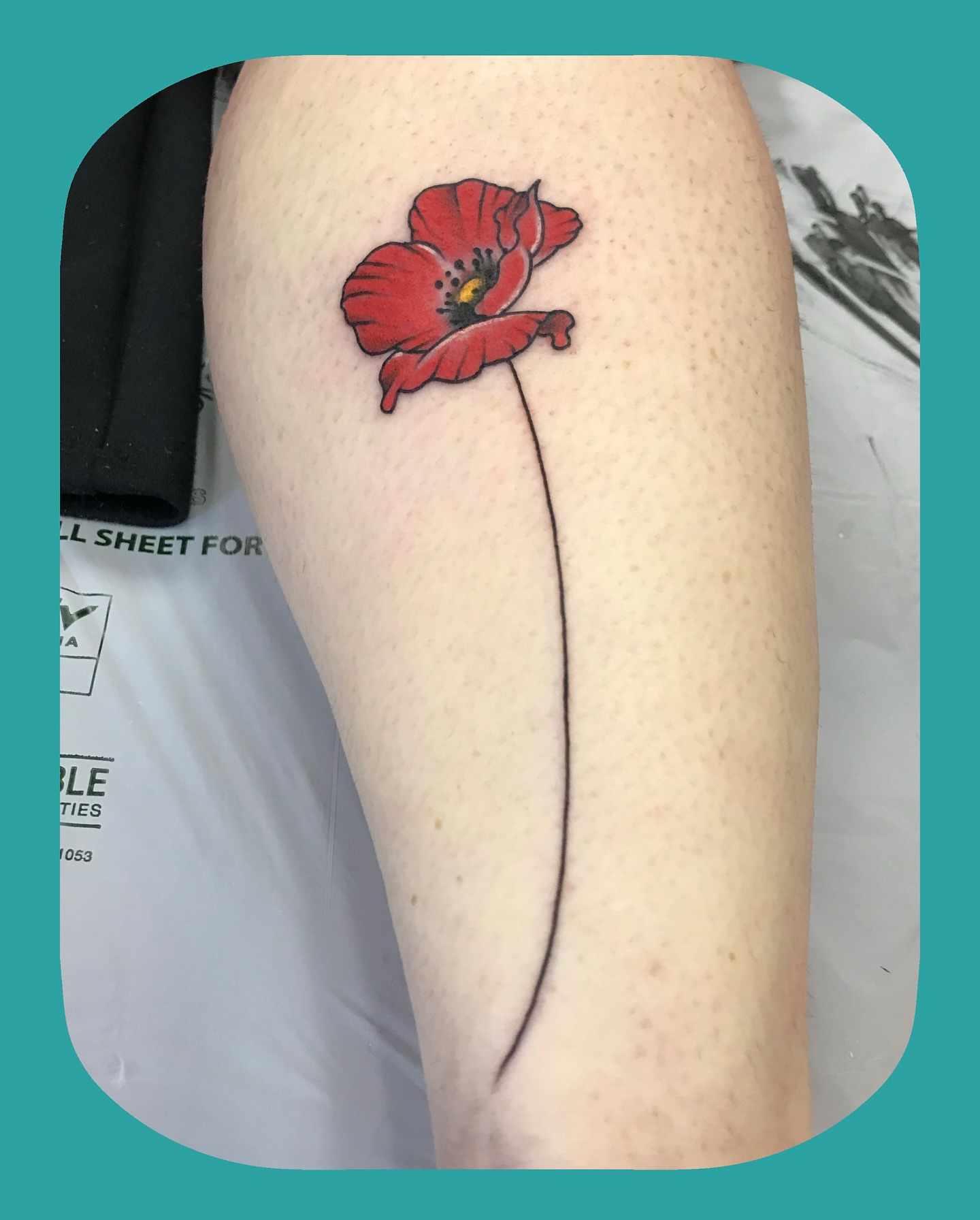 Red poppy realism tattoo on the thigh by Chris Chapman