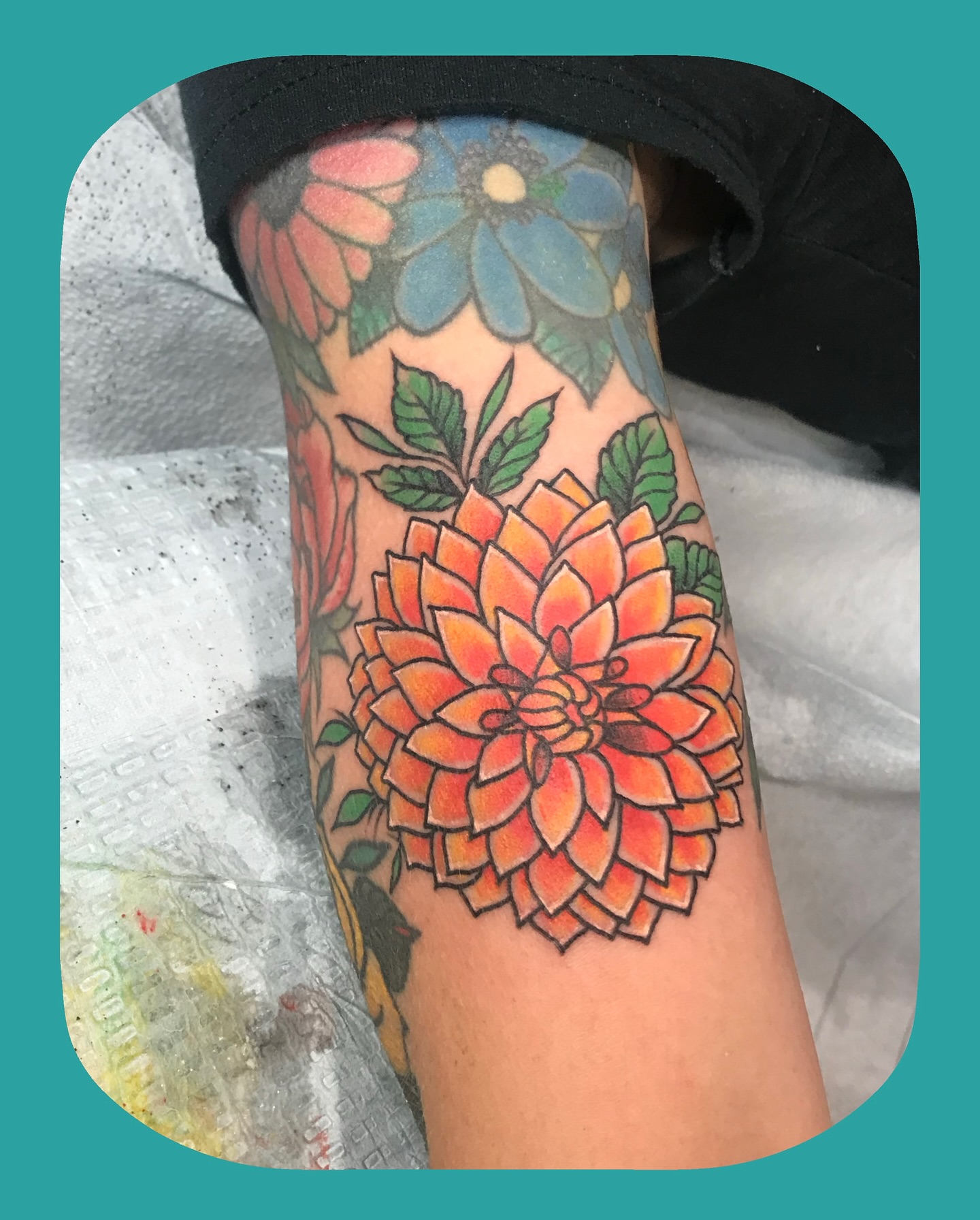 Dahlia American traditional tattoo on the forearm by Chris Chapman