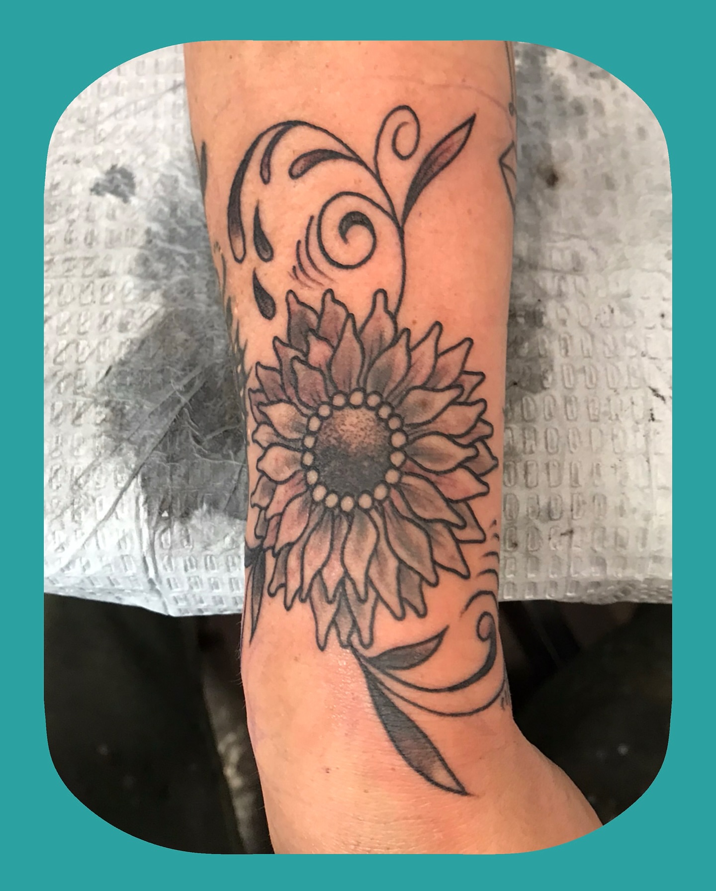 Sunflower black and grey tattoo on the forearm by Chris Chapman