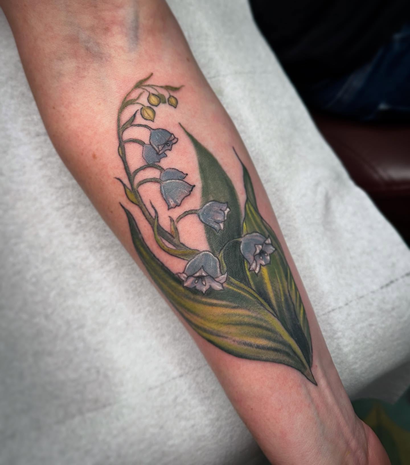 Lily of the valley realism tattoo on the forearm by Heather Tattoos Danvers MA