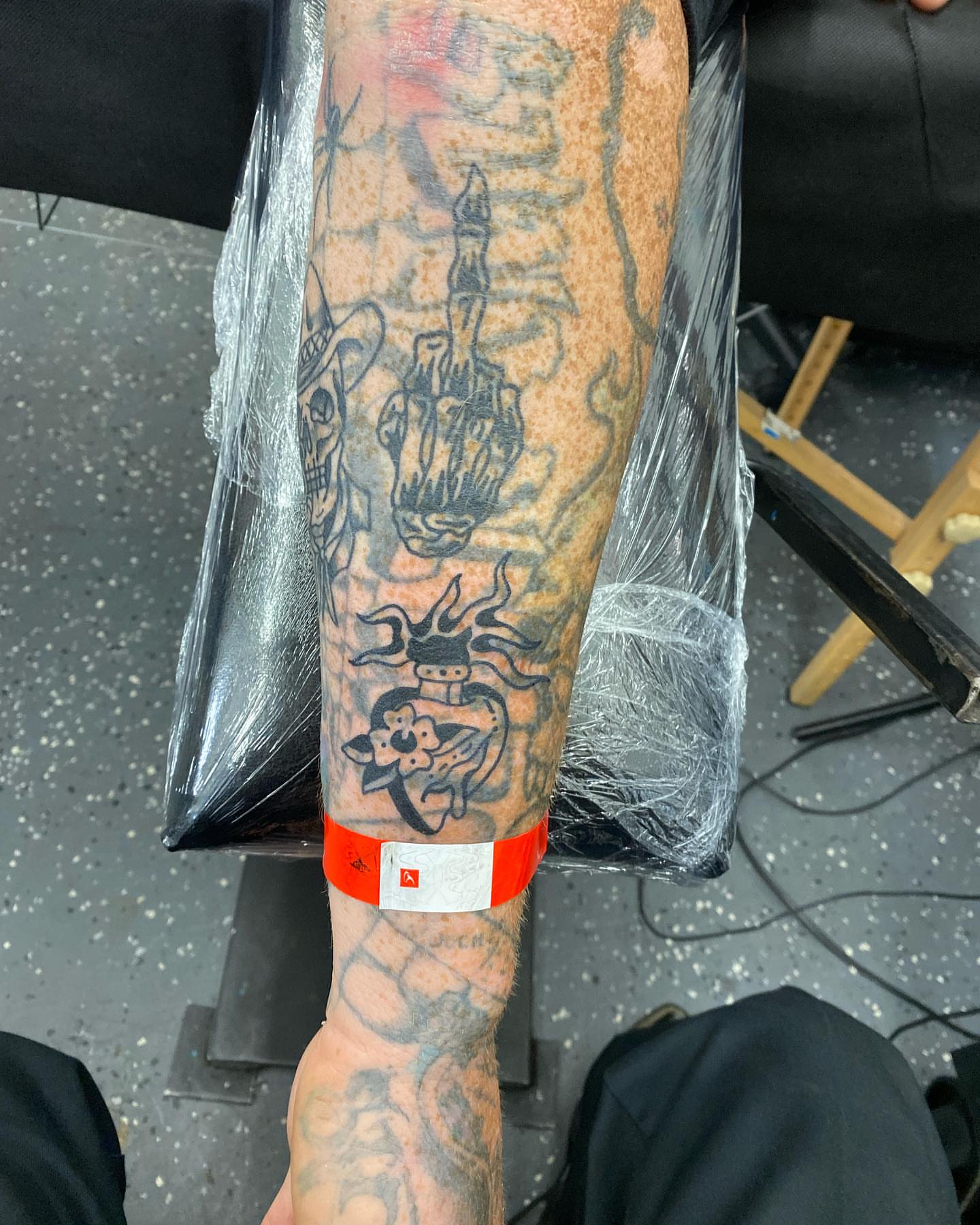 Heart with octopus tentacles neo-traditional tattoo on the forearm by Payton Prentice