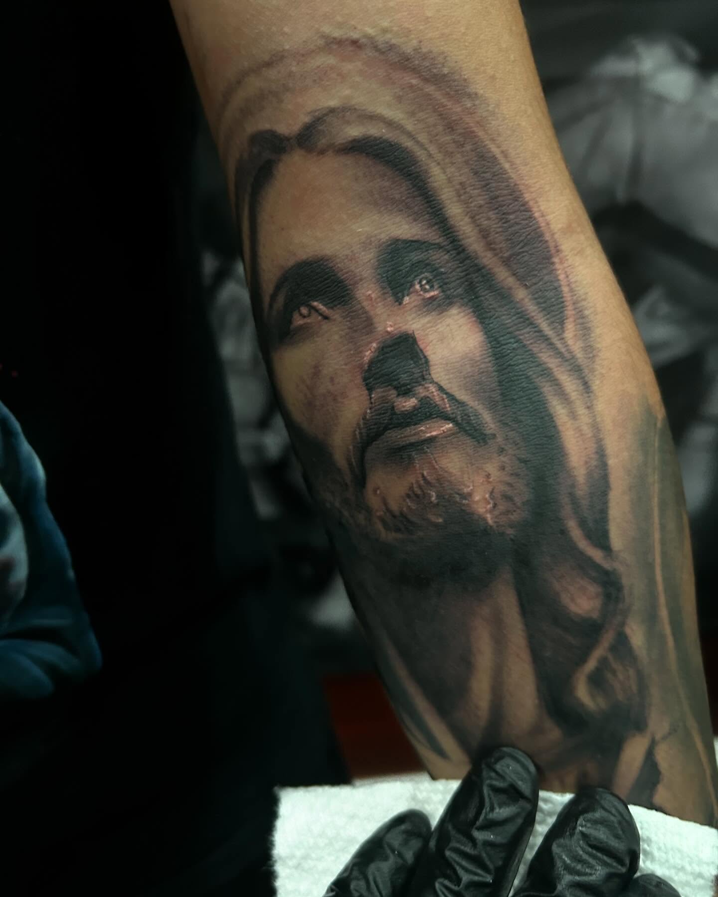 Religious figure realism tattoo on the forearm by Carlos