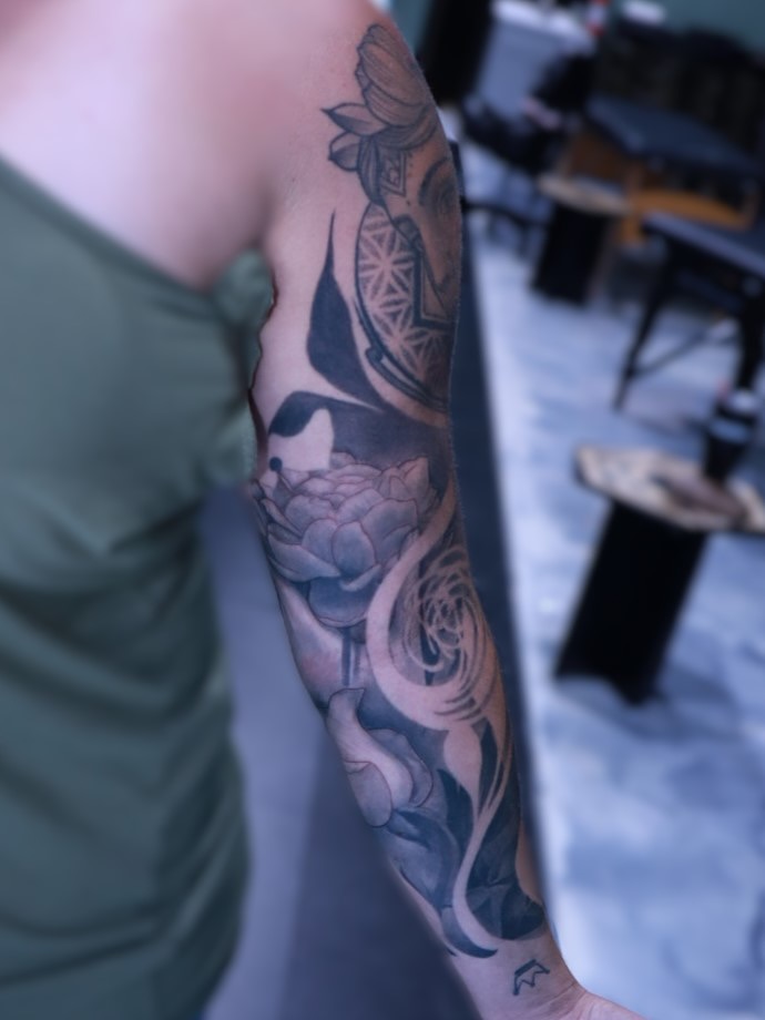 Lotus flower and abstract patterns geometric tattoo on the forearm by Mike j tattooer