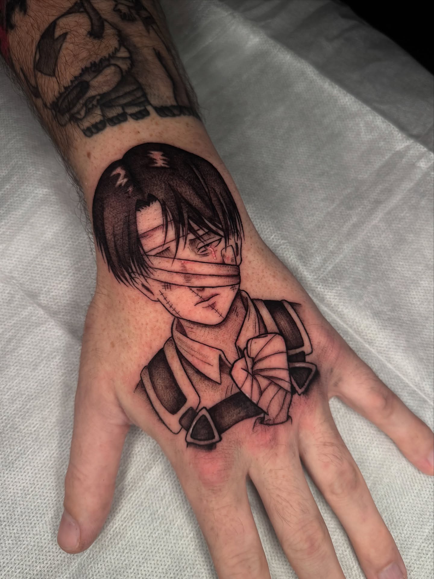 Anime character anime tattoo on the hand by kelsey hackett