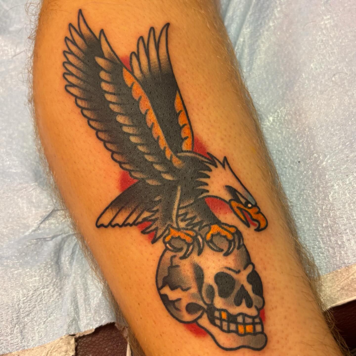 Eagle and skull American traditional tattoo on the forearm by @dannydoestattoos