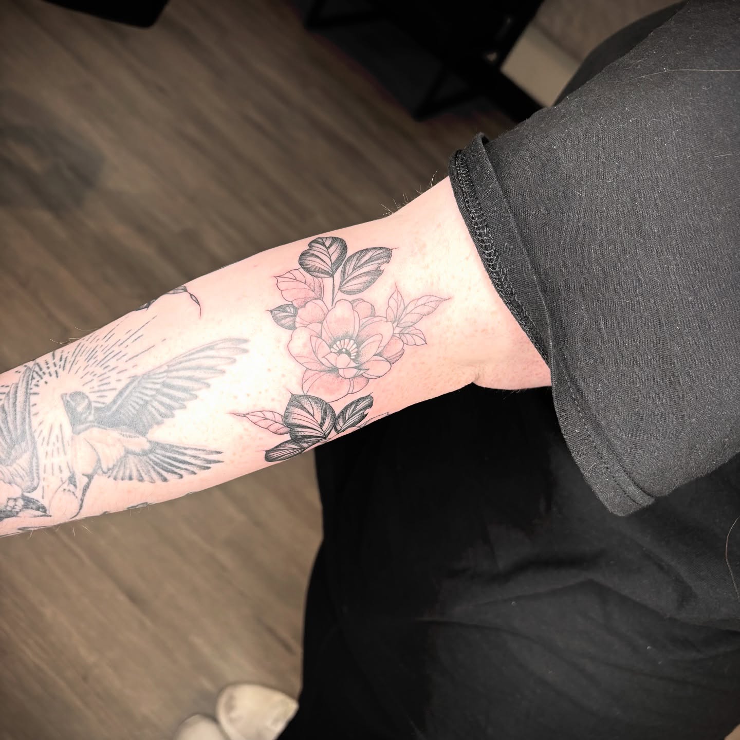 Bird and flowers American traditional tattoo on the forearm by Amber N