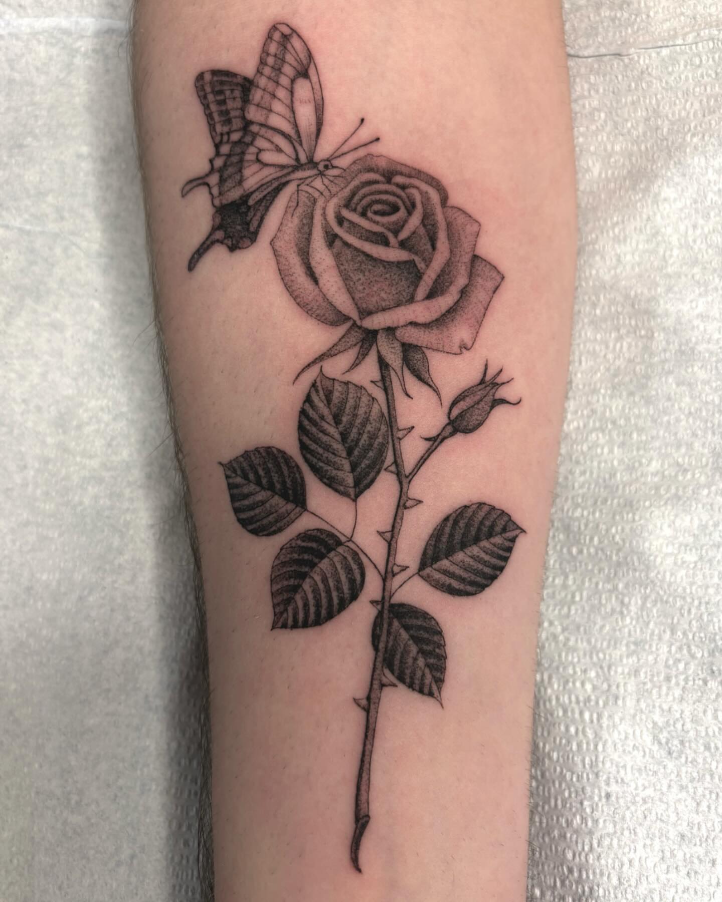 Rose and butterfly realism tattoo on the forearm by Jake Hodson, Nashville, Tennessee