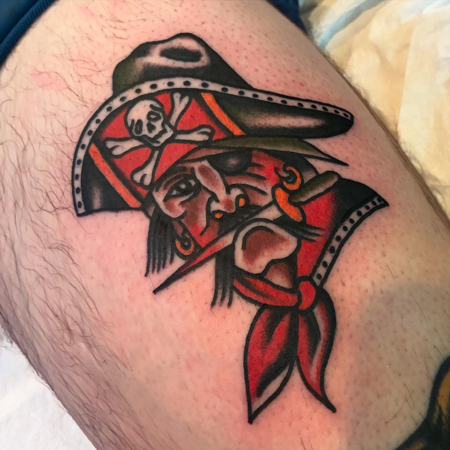Pirate American traditional tattoo on the thigh by Mike Hudgins