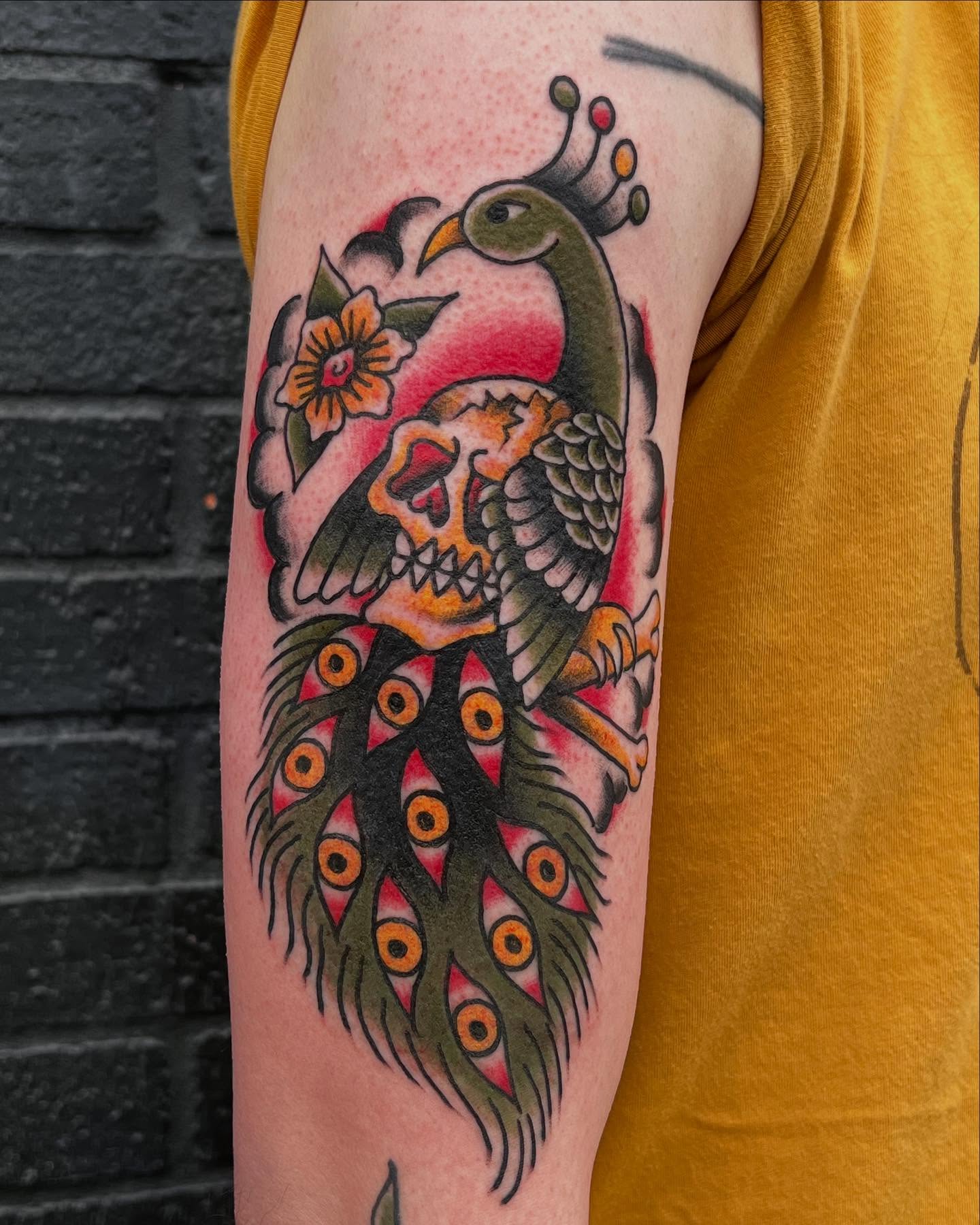 Peacock and skull American traditional tattoo on the forearm by Scott Allen