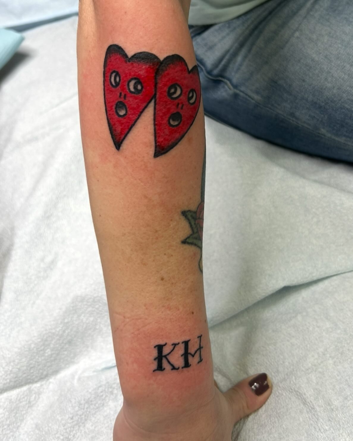 Split heart dotwork tattoo on the forearm by Elizabeth Niederkorn