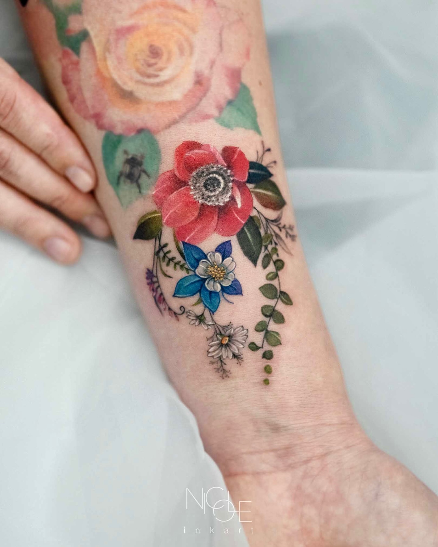 Floral bouquet watercolor tattoo on the forearm by 𝐍𝐈𝐂𝐎𝐋𝐄 𝐋