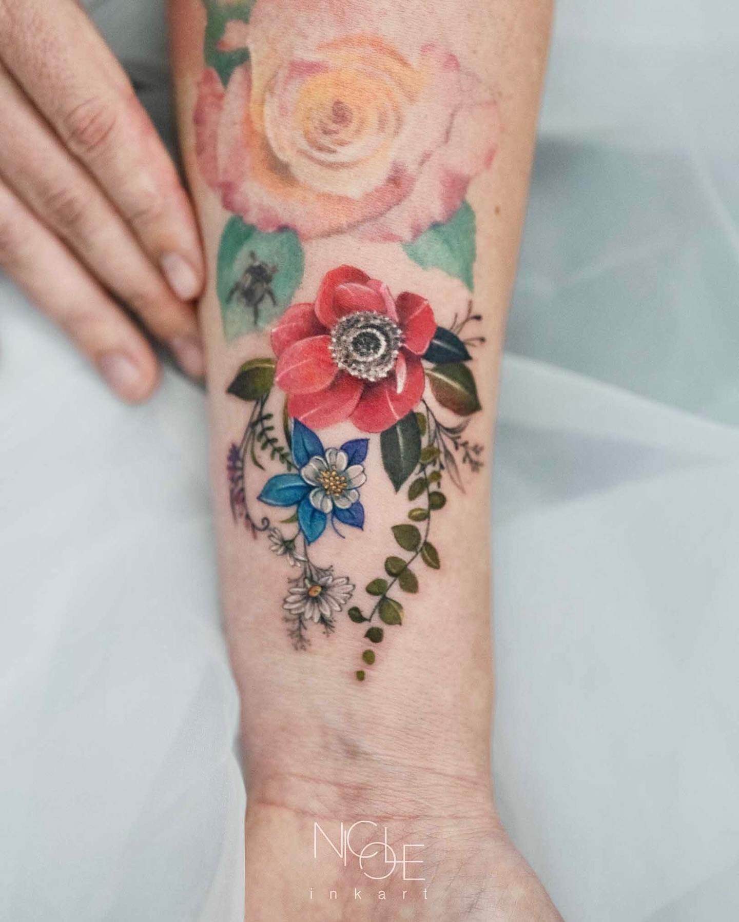 Floral arrangement watercolor tattoo on the forearm by 𝐍𝐈𝐂𝐎𝐋𝐄 𝐋