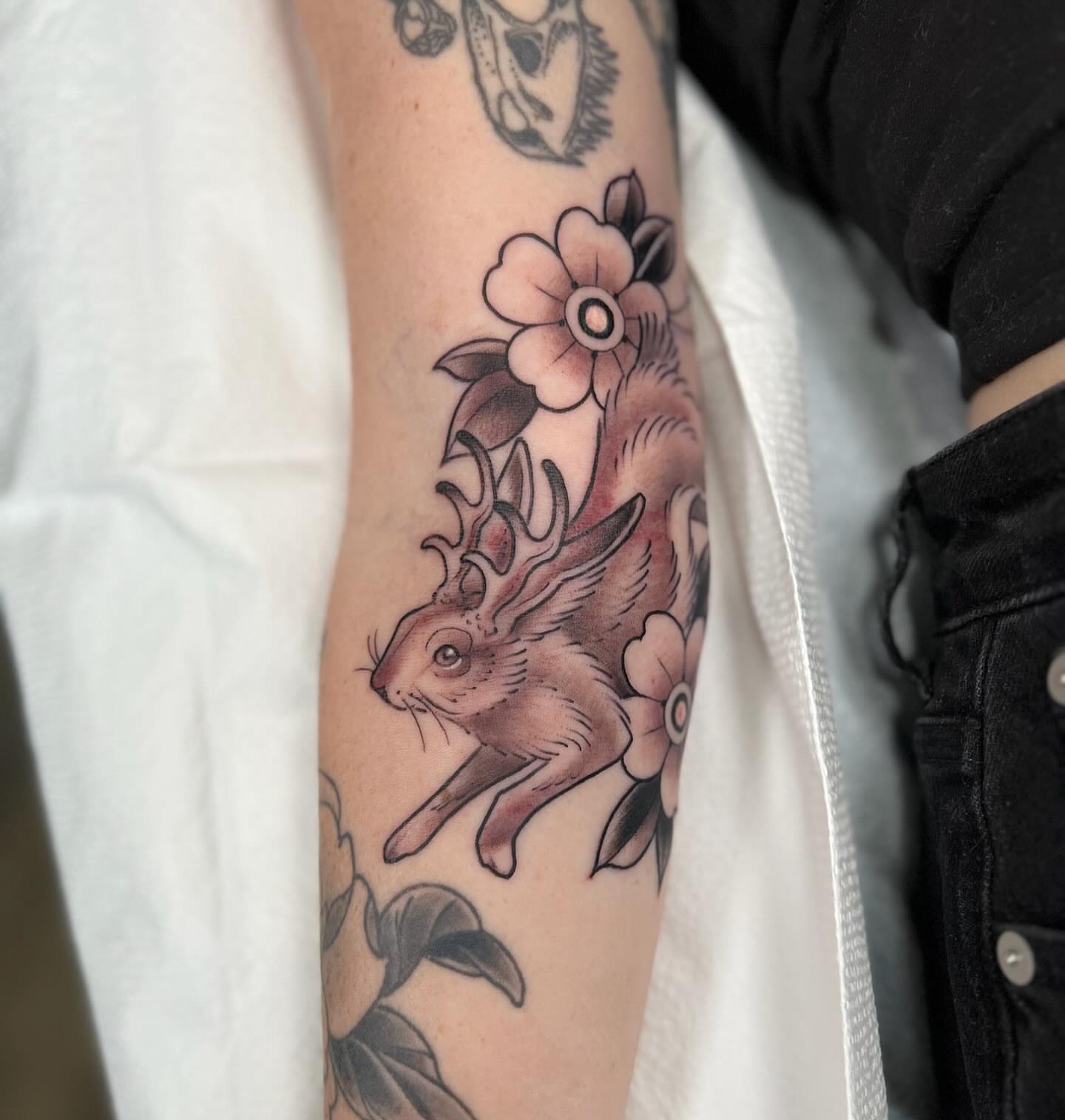 Rabbit and flowers American traditional tattoo on the forearm by Kyle Olson, Salt Lake City, Utah