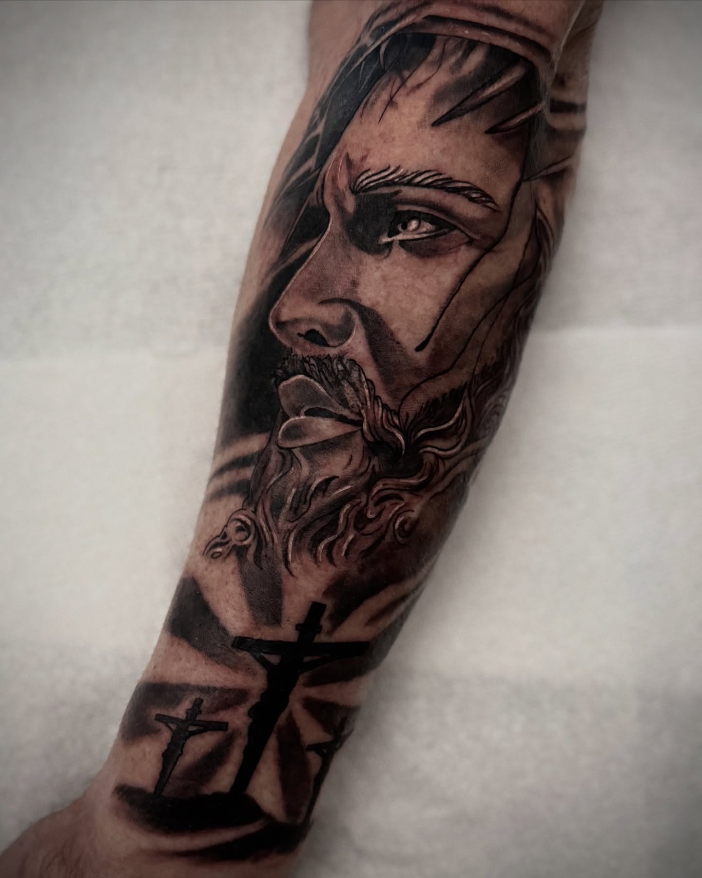 Religious figure realism tattoo on the forearm by Ashley Laine Evans