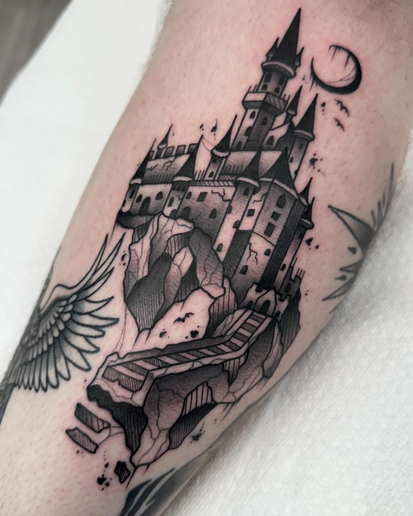 Castle ruins realism tattoo on the forearm by Katie Kelley
