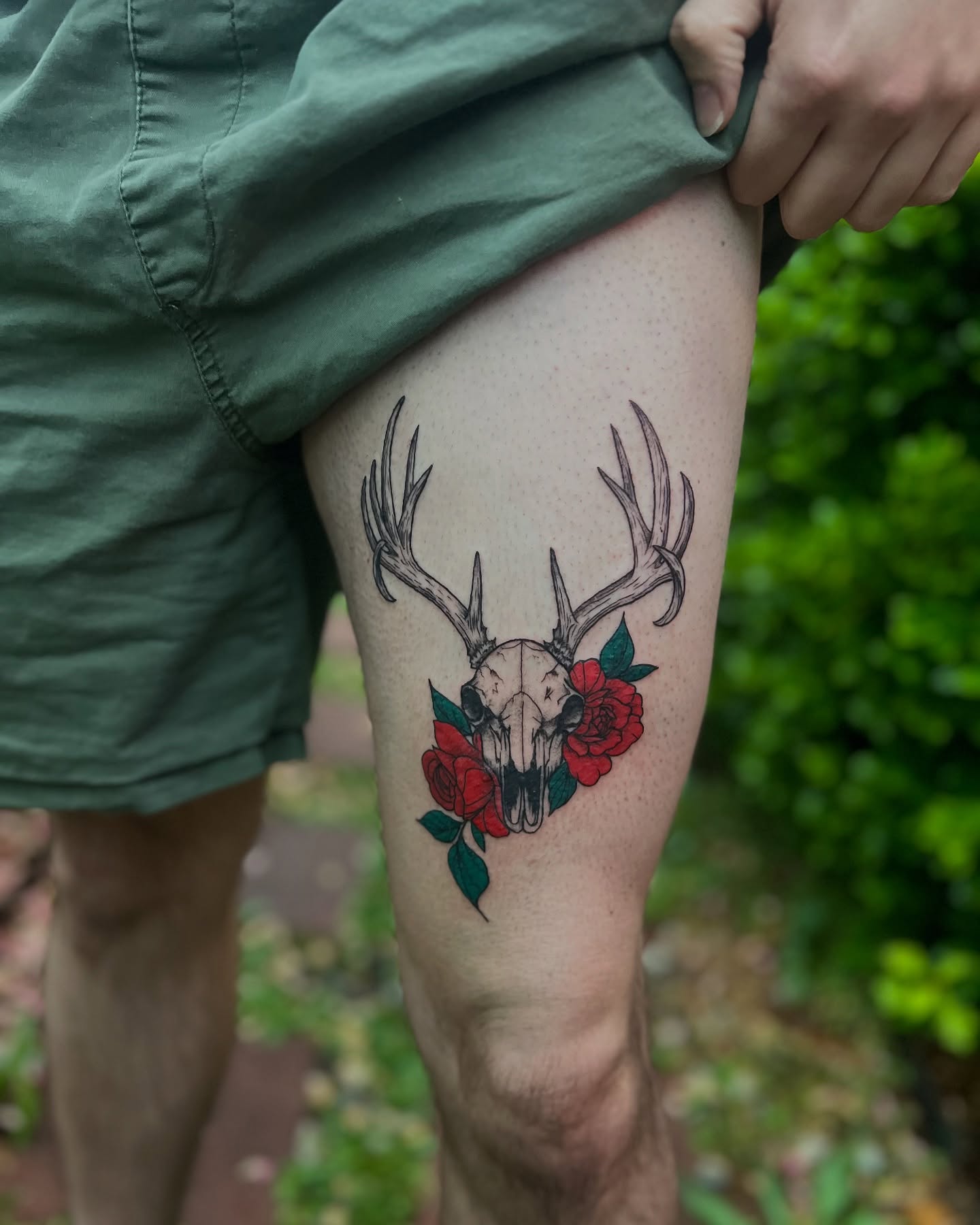 Deer skull with roses realism tattoo on the thigh by Rose DeLisse