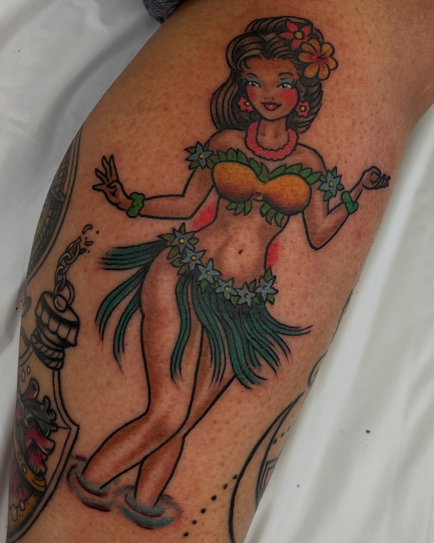 Hula dancer American traditional tattoo on the thigh by Steve Tiberi