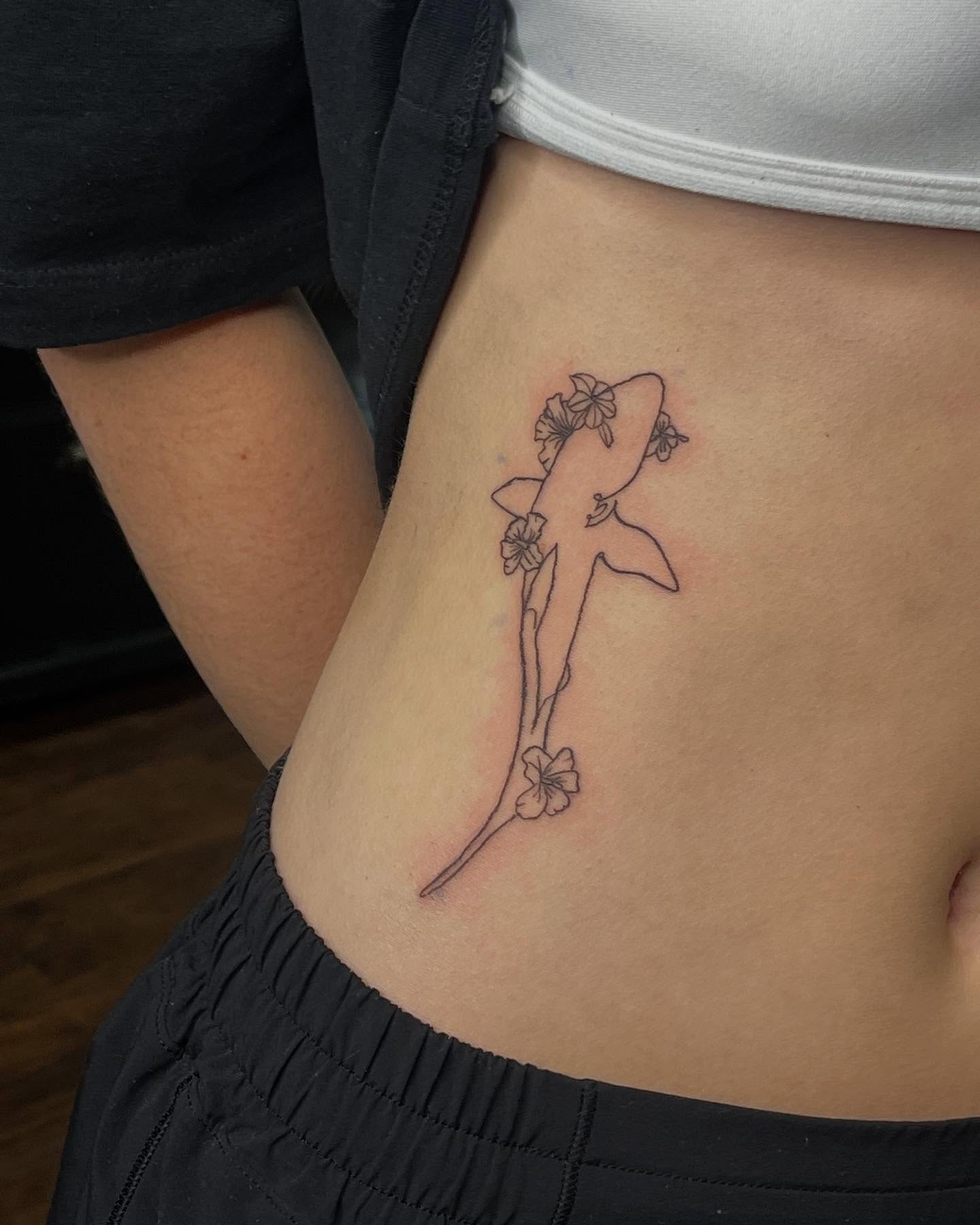 Shark with flowers black and grey tattoo on the ribs by destiny🌞