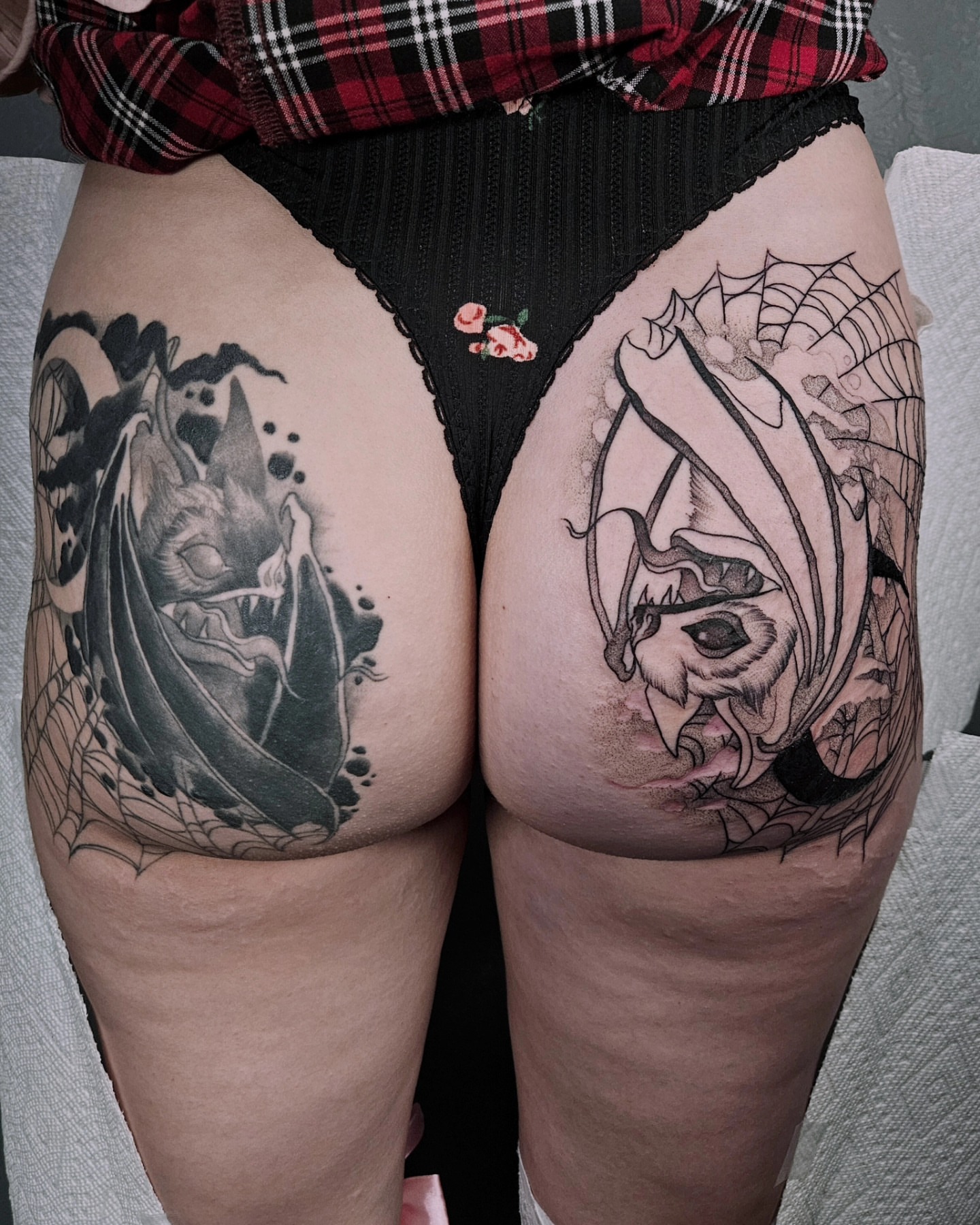Bat and spider web black and grey tattoo on the thigh by Sabrina Wagner