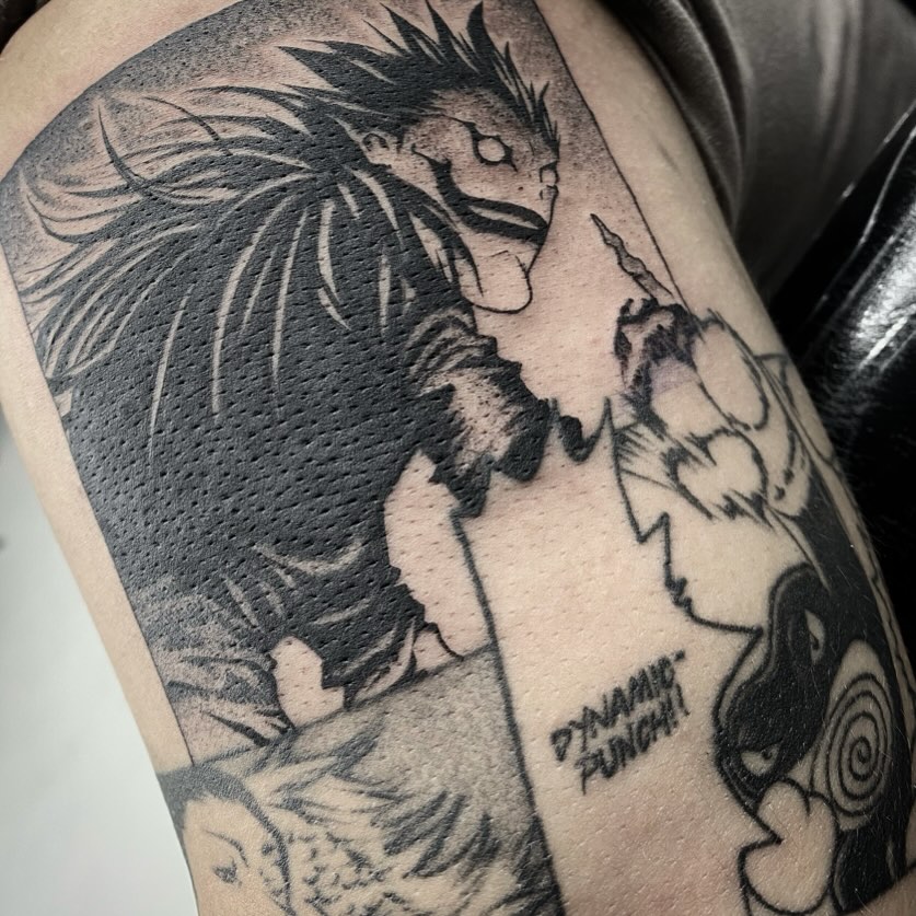 Dynamic punch anime tattoo on the upper arm by Angel Rodriguez