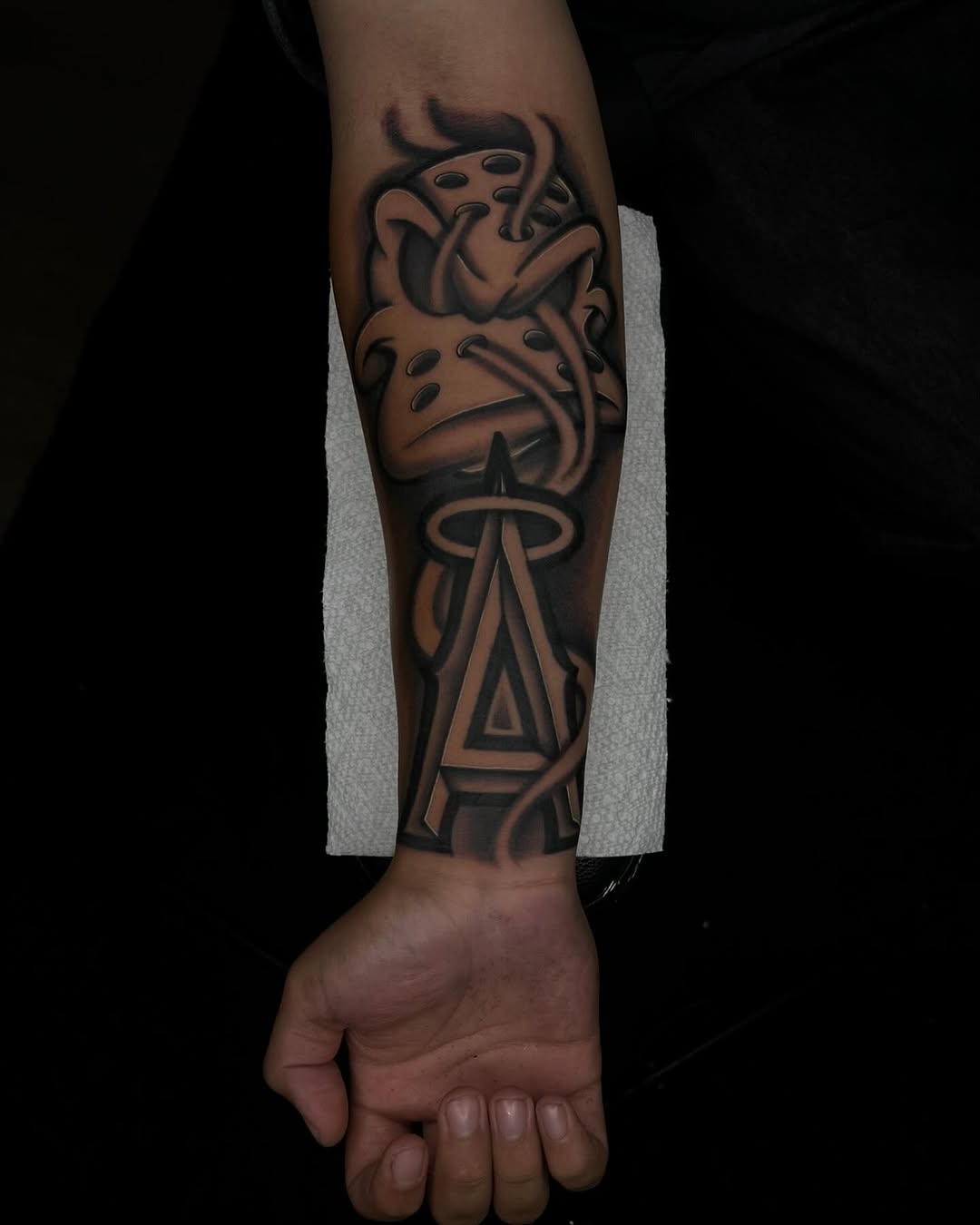 Hockey mask and letter A realism tattoo on the forearm by Tattoo Artist